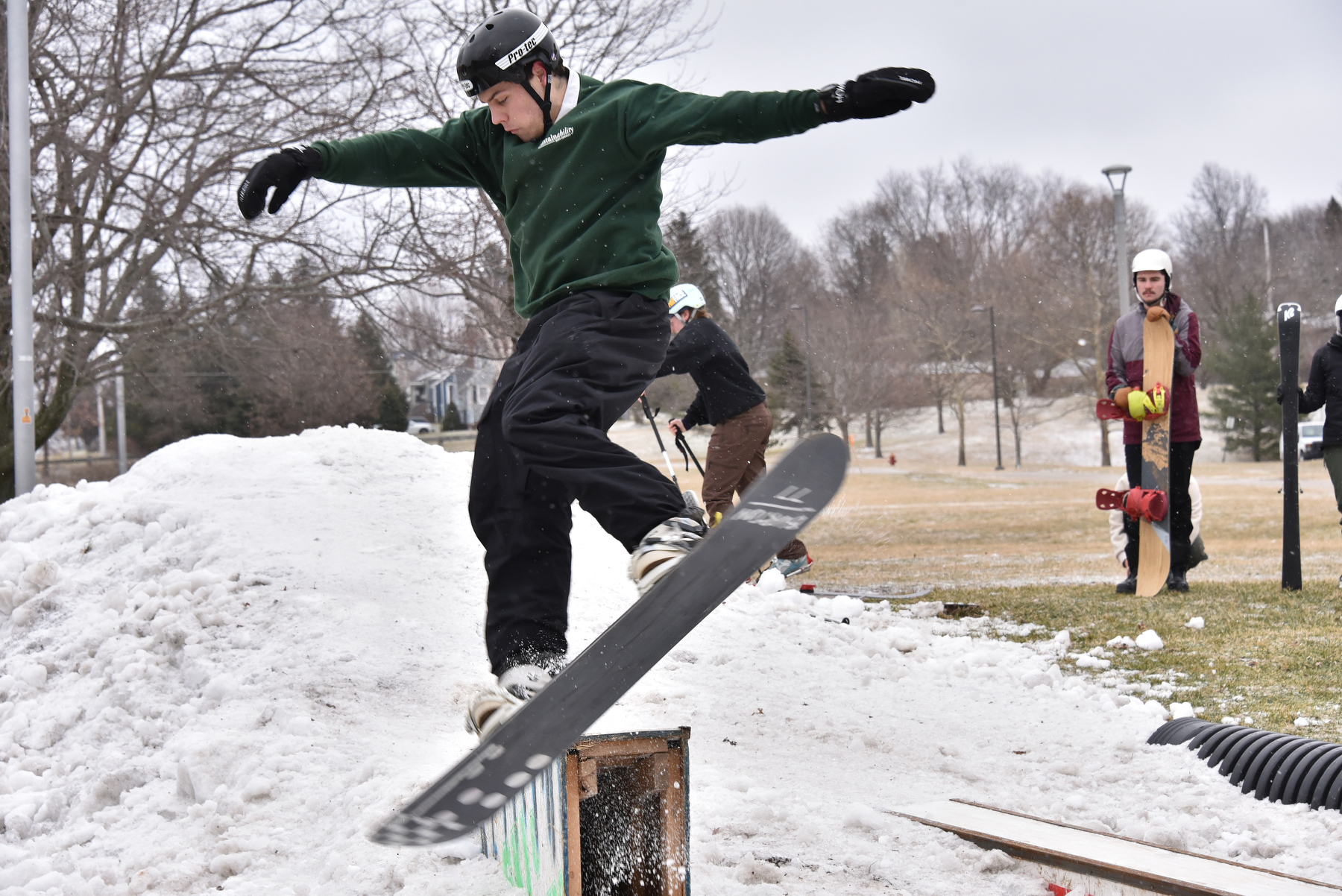 The Oswego Ski and Snowboard Club's annual Rail Jam on Feb. 17 was a free and open event for enthusiasts of all skill levels. Pictured is Jack Donahue, a technology education major, using a snowboard on some jumps.