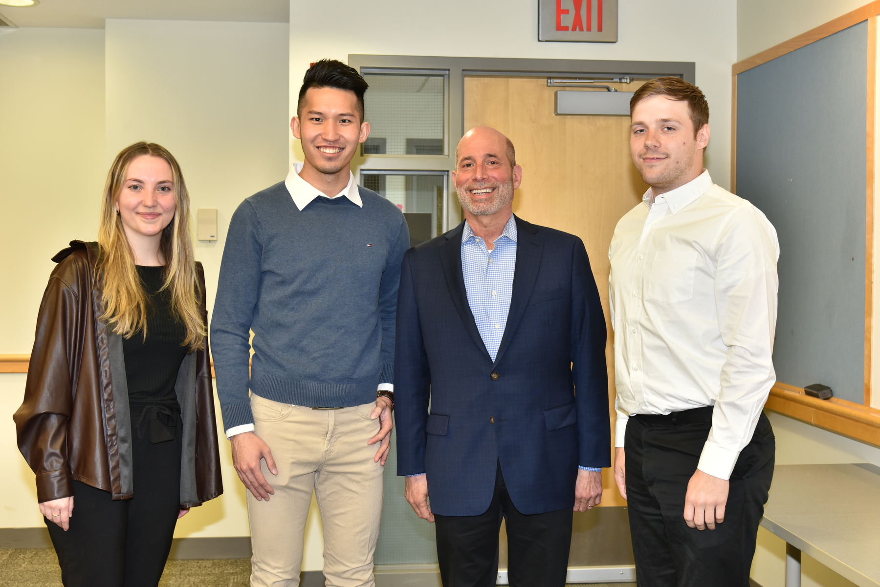 Allan Shaw (third from left), a 1986 alumnus and CFO of Portage Biotec  Inc., served as Quest keynote speaker for the day celebrating scholarly and creative activity. Gathered with Shaw before the talk, held in Marano Campus Center auditorium, are students in the School of Business, from left: Leanna Costello, Dee "Eason" Sheng Lee and Michael J. Saalfrank.