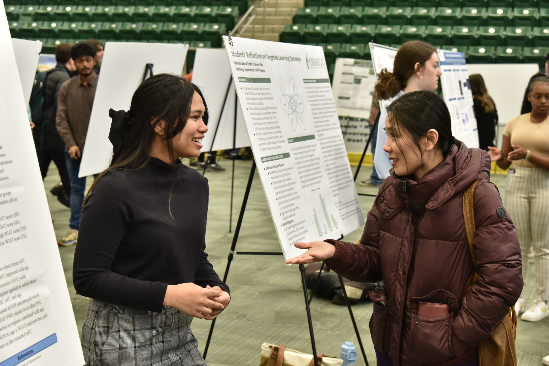Angela Gori (left) talks April 19 at Quest with psychology department faculty member Sien Hu about her research into “Age-Related Changes in the Resting State Functional Connectivity of Hippocampus and the Effects of Academic Achievement.”