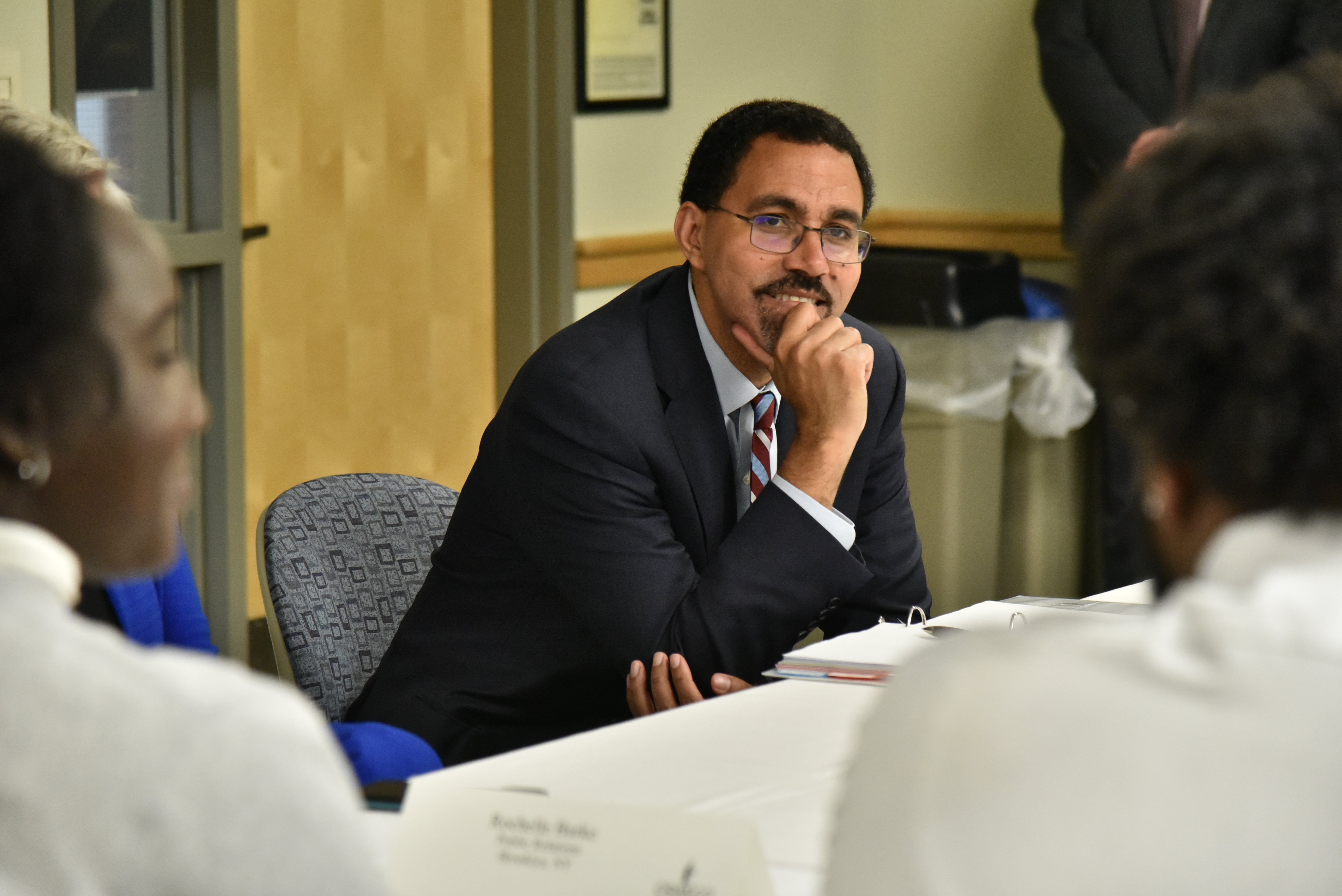 Chancellor John B. King Jr. listens intently as students introduce and talk a little about themselves