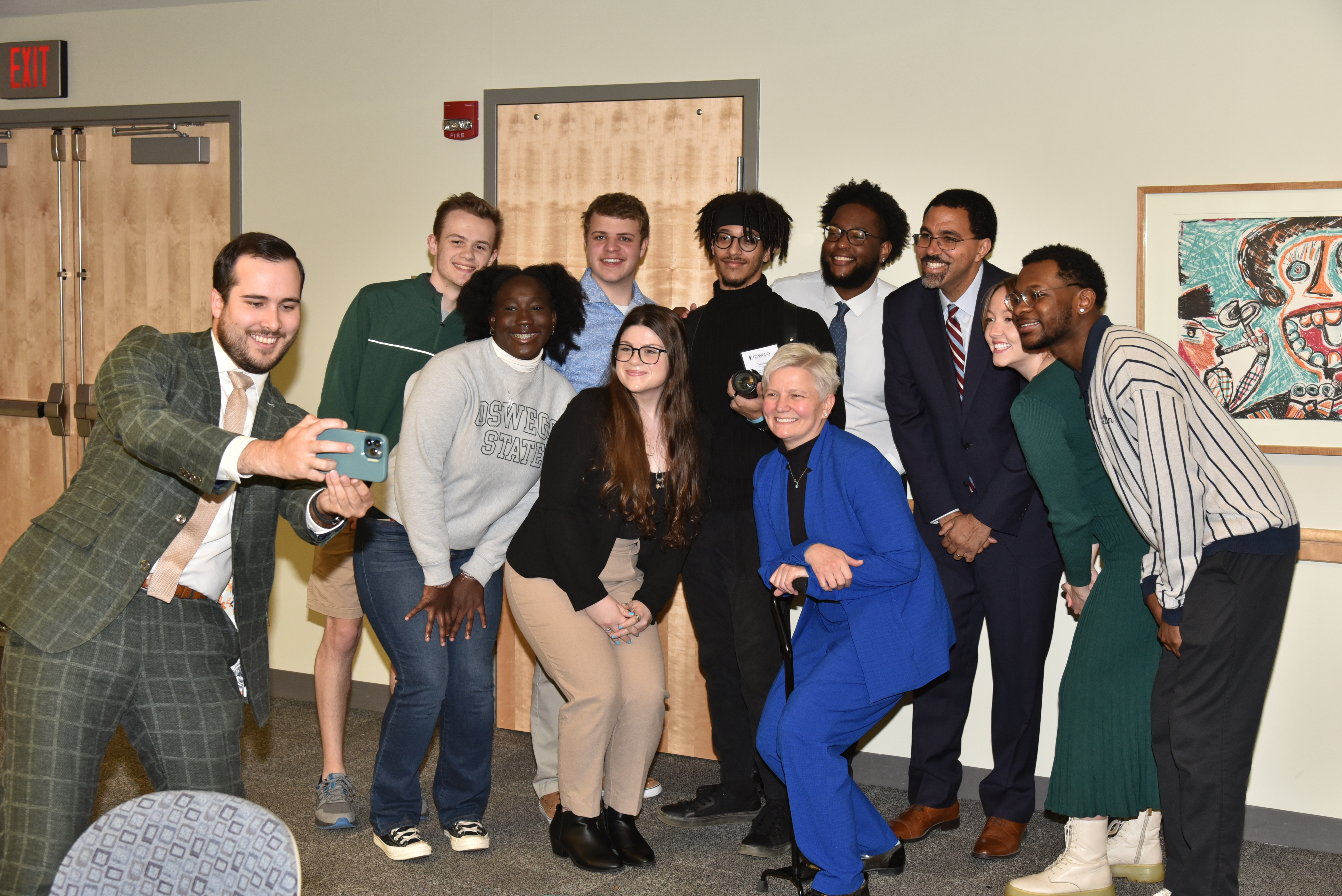 Chancellor John B. King Jr. (top, third from right) takes a selfie with students