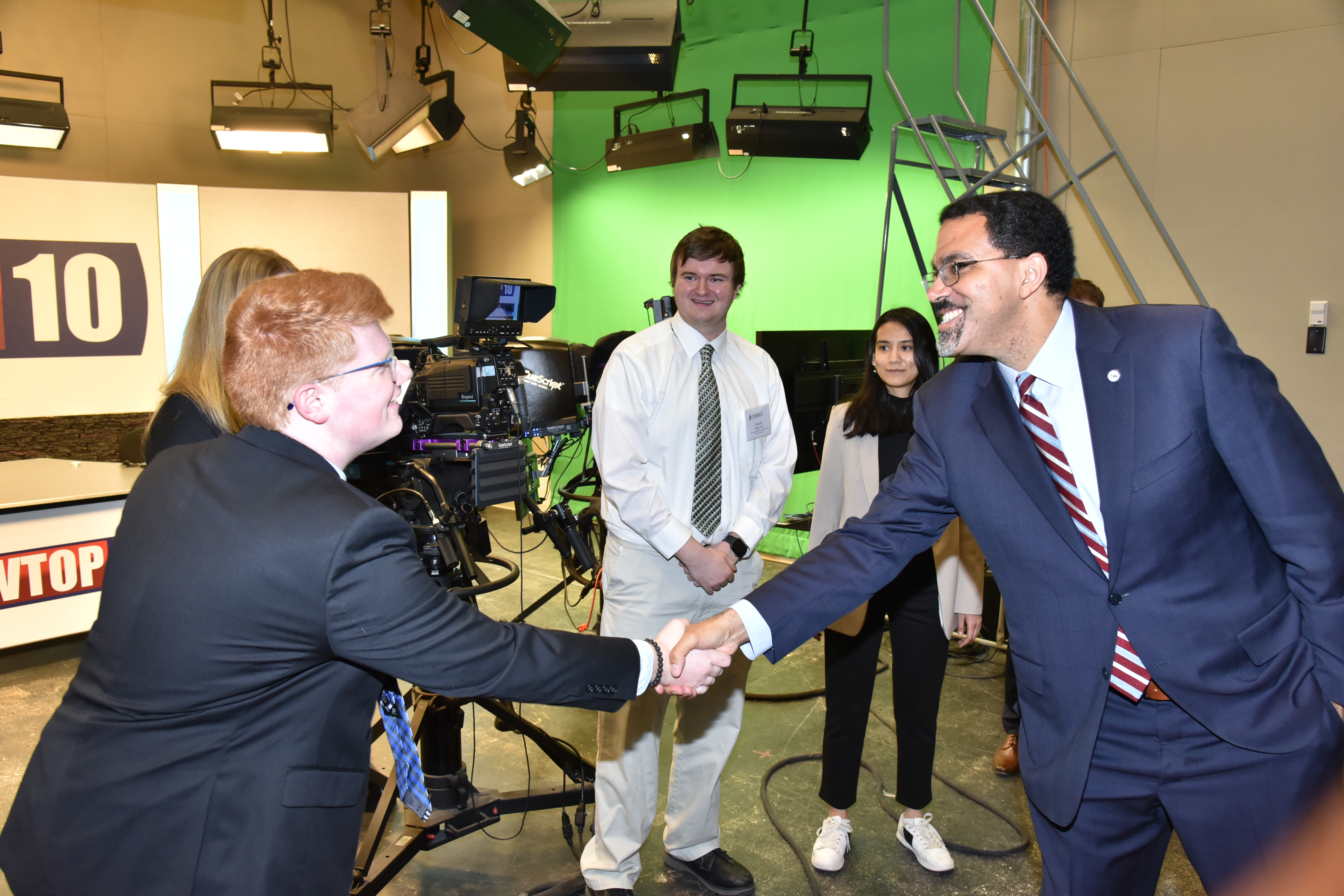 Chancellor John B. King Jr. greets Scott Brubaker and the team with student TV station WTOP
