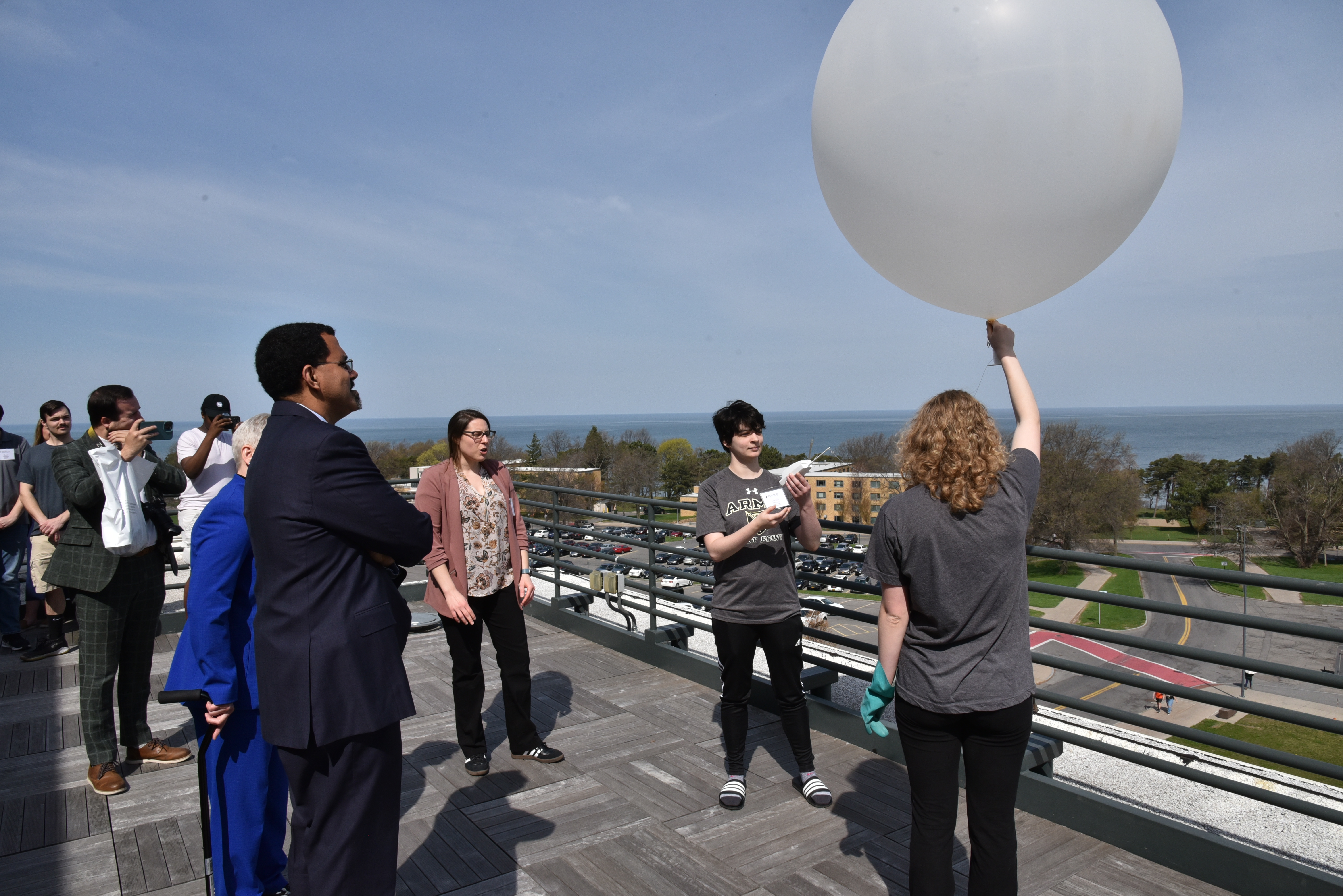 Chancellor John B. King Jr. watches a weather balloon launch from the roof of the Shineman Center