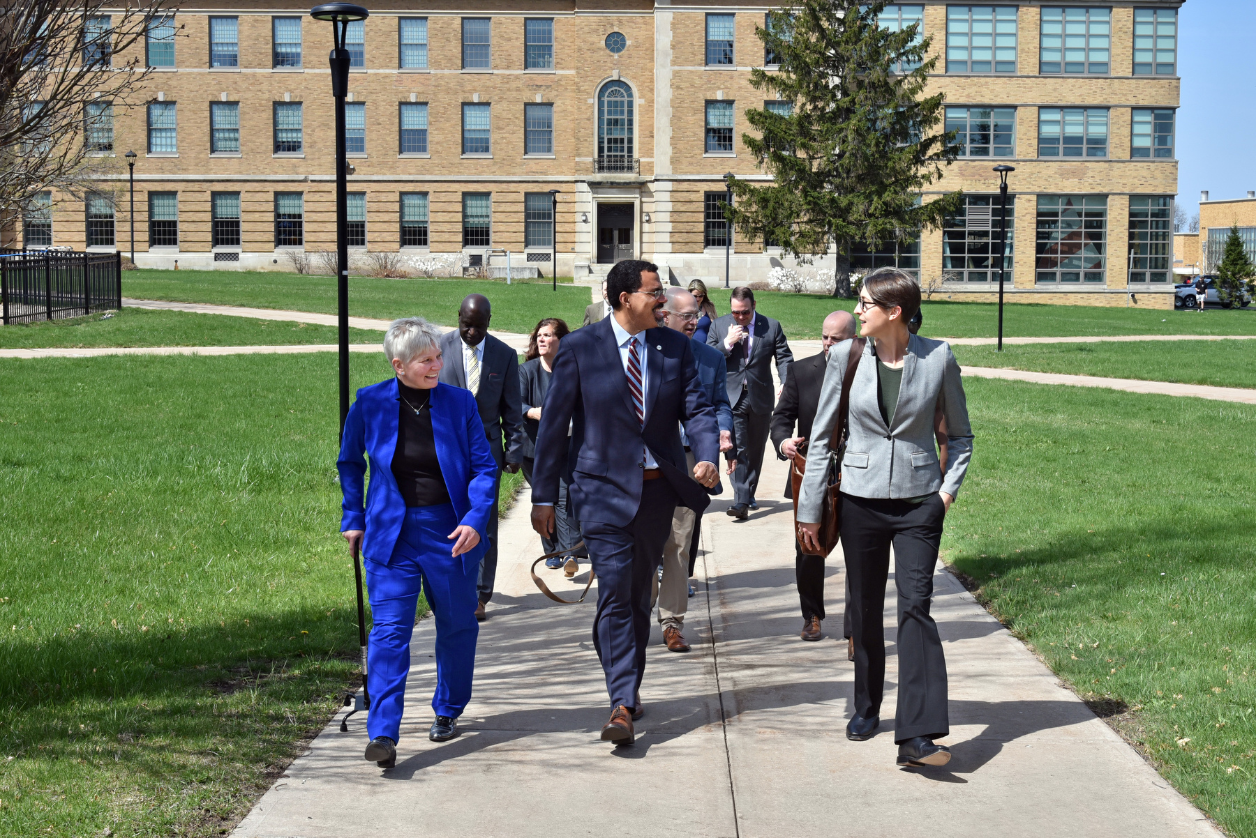 SUNY Chancellor John B. King Jr. visited the SUNY Oswego campus on April 21, meeting with students, touring the campus with faculty and staff, and learning more about the university's programs and facilities. He is pictured here outside Rich Hall talking with SUNY Oswego's Officer in Charge Mary C. Toale and Chief of Staff and Executive Director of Strategic Initiatives, External Partnerships and Legislative Affairs Kristi Eck.