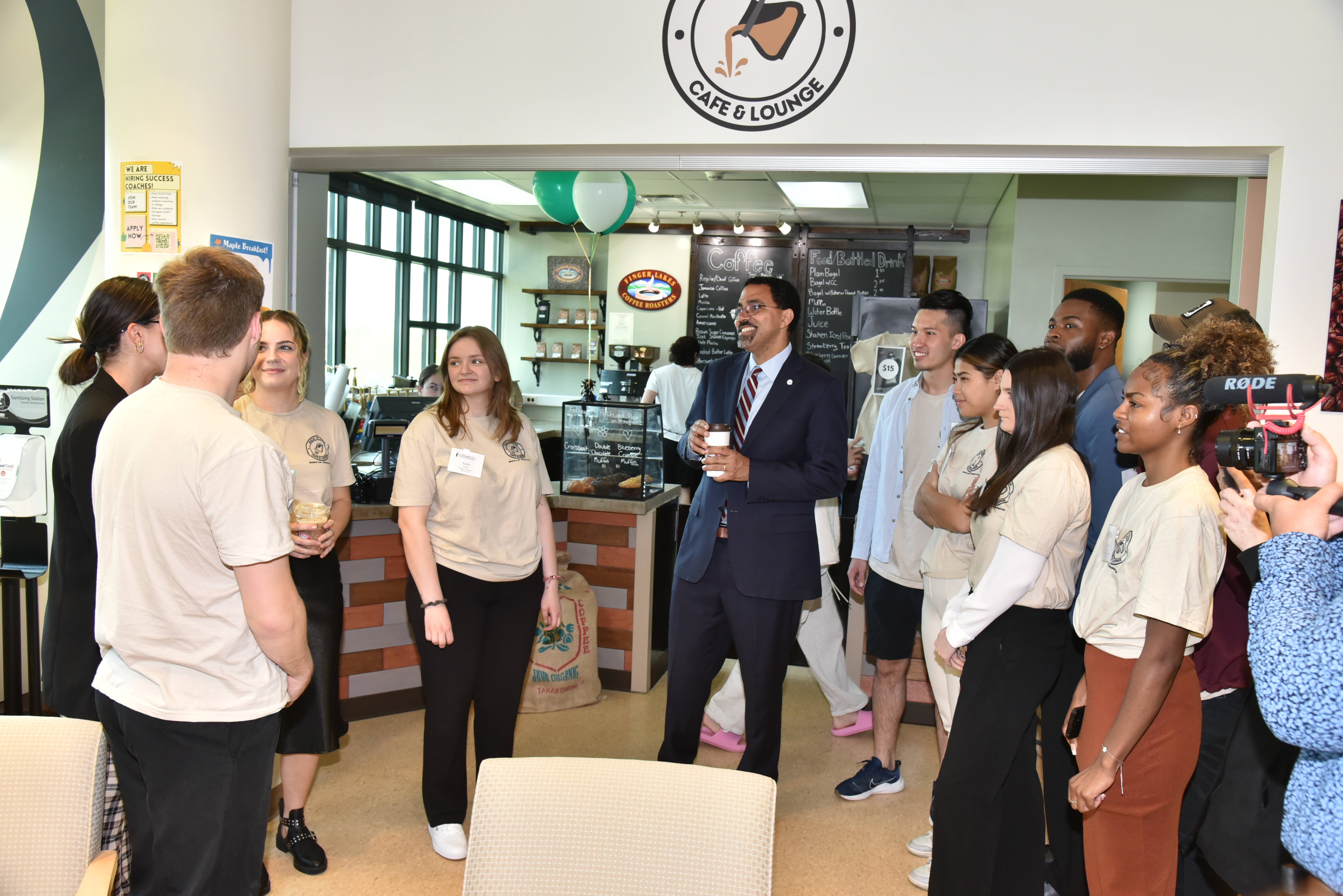 Chancellor John B. King Jr. speaks with the students who run the Rich N' Pour Cafe