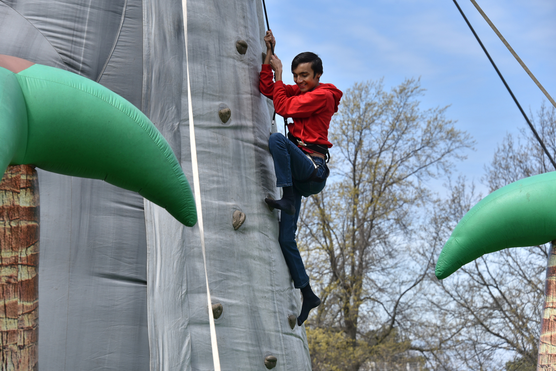During the May 5 OzFest, Saurav Lamichhane, a freshman computer science major, enjoys the heights of the rock climbing wall.