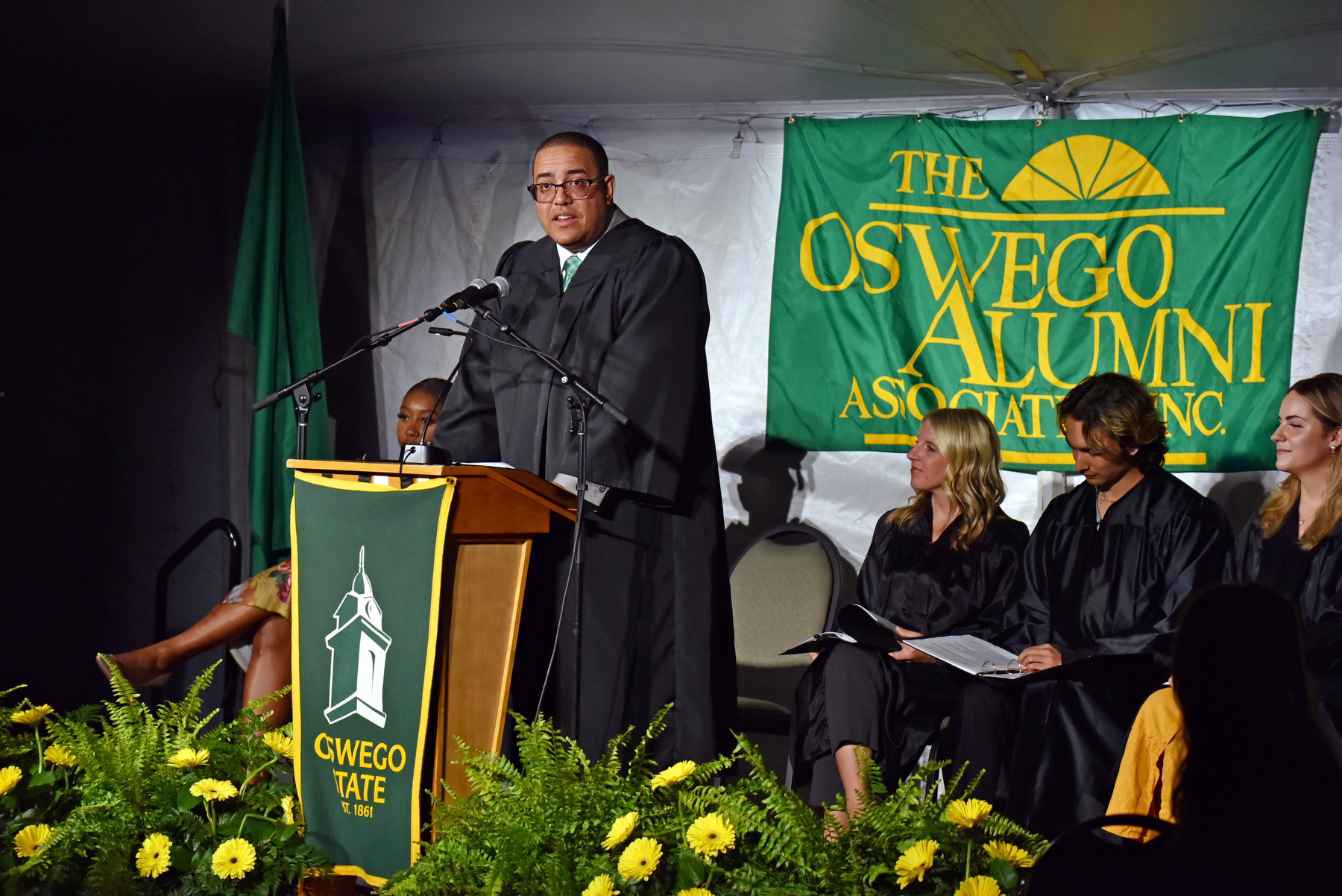 Gabriel Almanzar ’05, creative director for CBS News, delivered the keynote address at the 2023 Commencement Eve Torchlight Ceremony on May 12. The Torchlight Ceremony is one of Oswego’s long-standing traditions in which university leadership and other alumni pass the flame from the Torch of Learning to members of the graduating class, while welcoming these newest members of the Oswego Alumni Association. Almanzar earned a bachelor of fine arts in graphic arts with a minor in Spanish from SUNY Oswego
