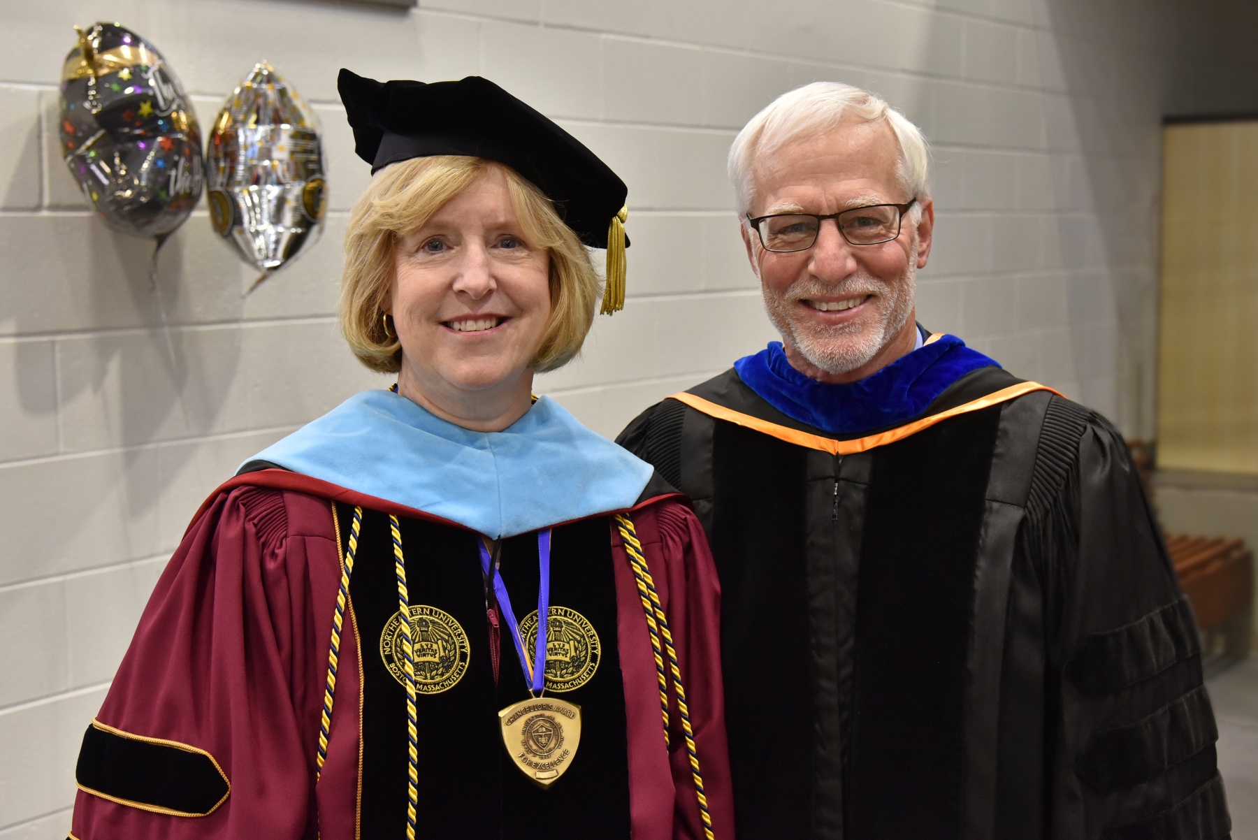 Retiring faculty staff are recognized at Commencement. Pictured during the 9 a.m. ceremony are Kathleen Evans, assistant vice president for academic support, and Jerry Oberst, senior associate director of admissions.