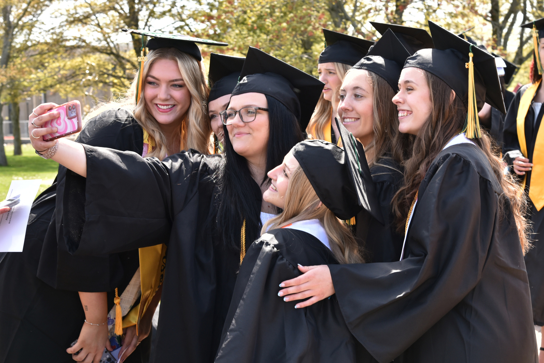 A group of graduating seniors in the School of Education take a selfie before heading into the Marano Campus Center for the 4 p.m. Commencement ceremony for the School of Communication, Media and the Arts and the School of Education.