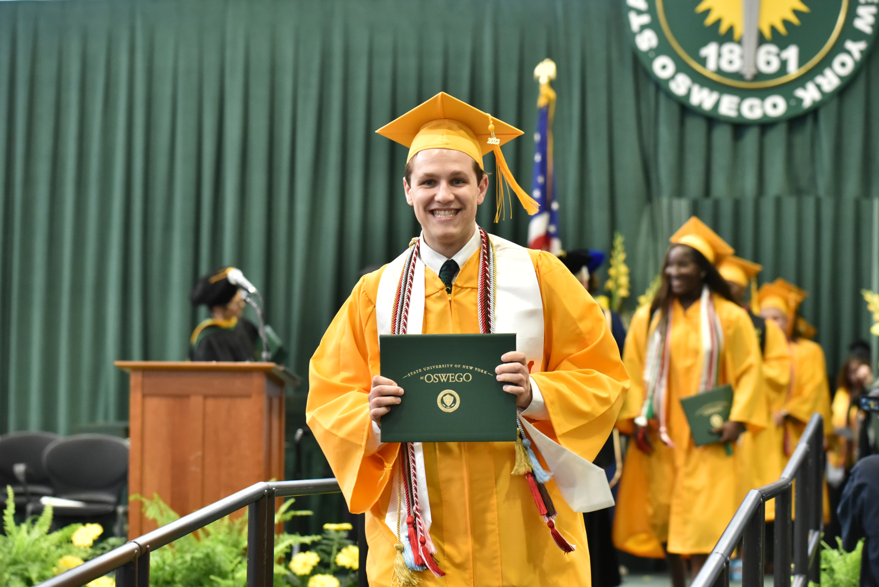 Nicholas Sweet, a theatre major graduating summa cum laude, smiles after receiving his degree from the School of Communication, Media and the Arts.