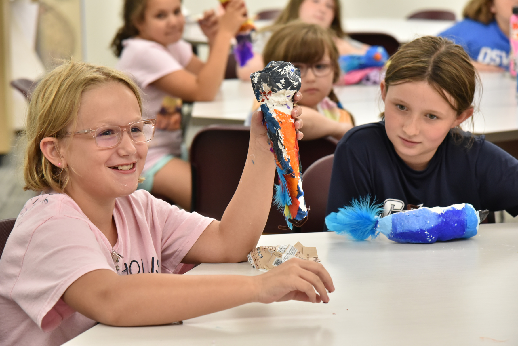 Students created colorful papier mache birds in Wilber Hall during the Sheldon Institute for Barbara Shineman Scholars program. 