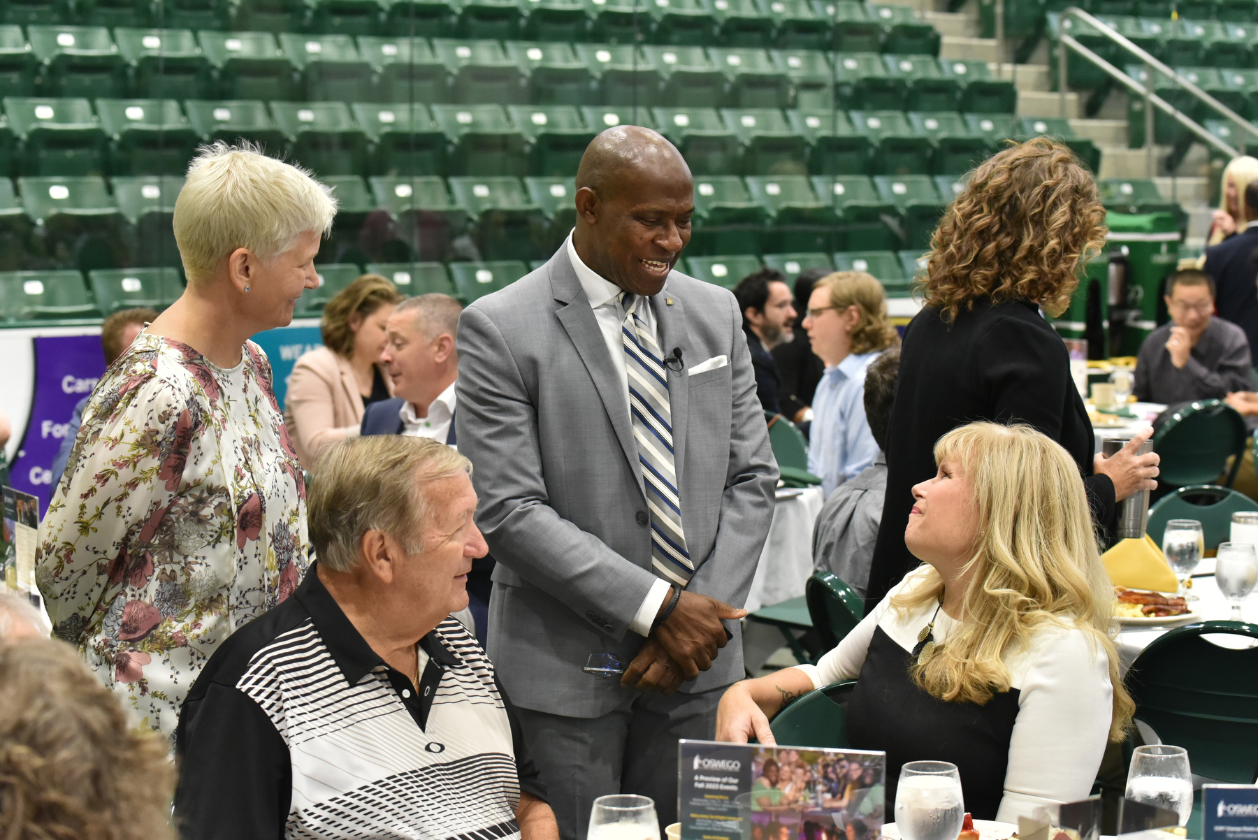 President Peter O. Nwosu (standing center) and Mary C. Toale, who had served as the university’s Officer in Charge and now is Deputy to the President for Strategy and Planning, talk during the Opening Breakfast Aug. 22 with Michele May of The Compass, one of the institution’s SUNY Chancellor's Award winners.