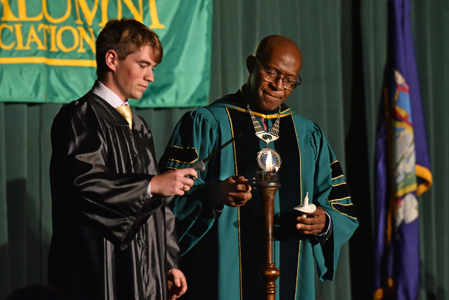 President Peter Nwosu and Student Association President Austin Davis, serving as Torchbearer, light the torch during the Welcoming Torchlight Ceremony