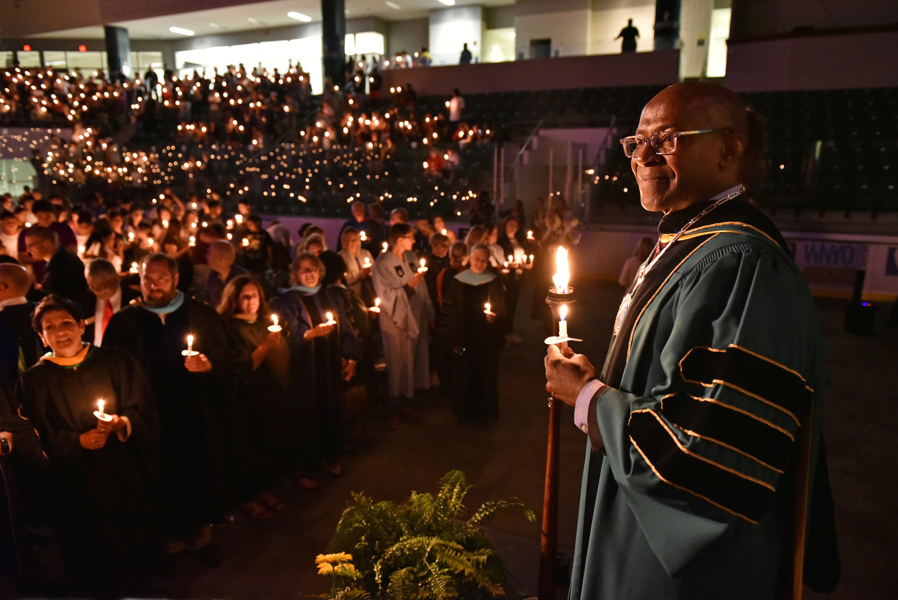 President Peter O. Nwosu stands on the platform as candles are lit during the Welcoming Torchlight Ceremony