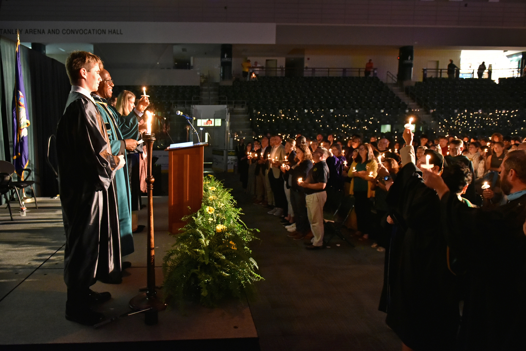 President Peter O. Nwosu stands with Student Association President Austin Davis ’25, who served as Torchbearer, student speaker Kae Jimenez ’25, emcee Kaylee Knapp ’24 and the audience of students, faculty and staff near the conclusion of the Welcoming Torchlight Ceremony.