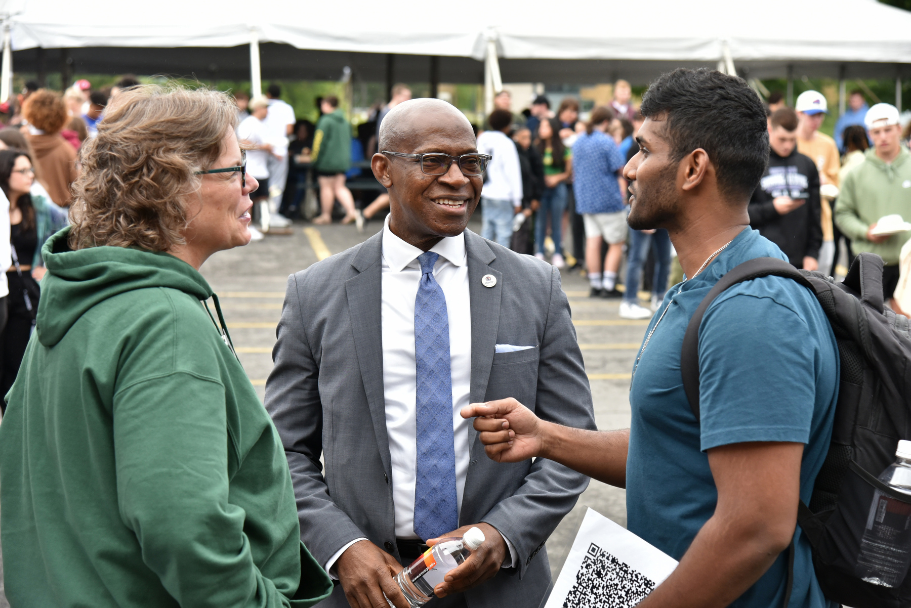 SUNY Oswego President Peter O. Nwosu and Kathleen Kerr, Vice President for Student Affairs, talk with graduate student Kranthi Kumar Erra during the Aug. 24 Taste of Oswego campus event which provided the campus community with delicious food from vendors and local restaurants in the greater Oswego area.