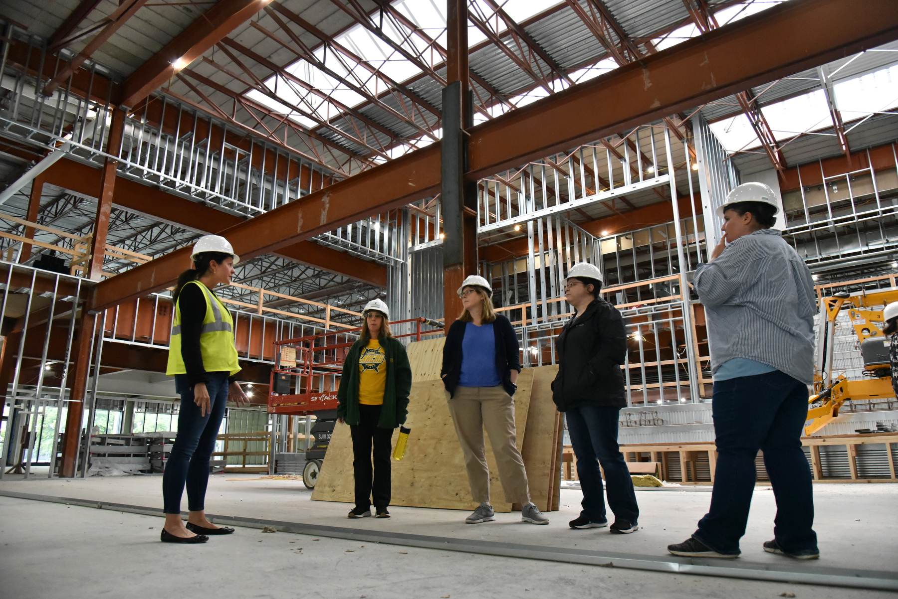Amy Enwright, of the Facilities Services-Major Projects Group, leads a tour Aug. 30 through Hewitt Hall during the building's renovation for its planned use for the School of Communication, Media and the Arts.