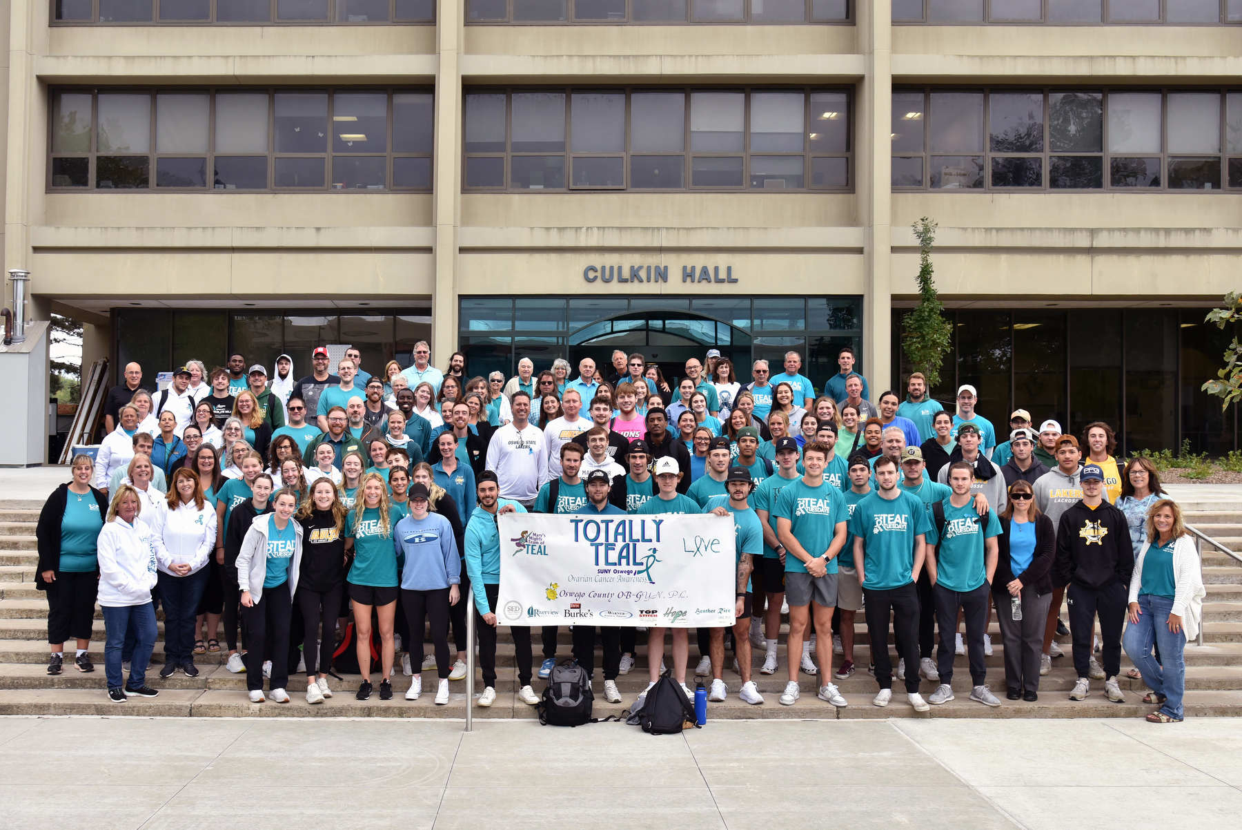 The campus community gathered for the National Ovarian Cancer Awareness Month group photo at Culkin Hall on Sept. 19, followed by a walk around the lagoon in remembrance of the late Mary Gosek