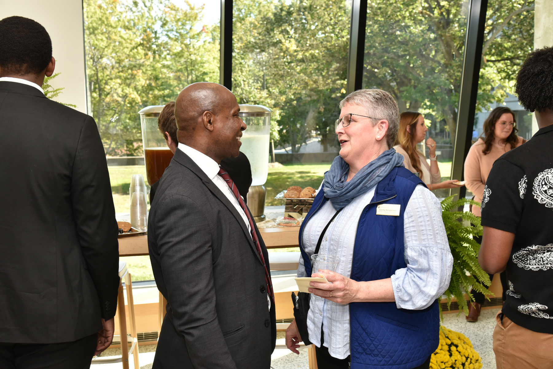 President Peter O. Nwosu talks with health promotion and wellness faculty member Sandy Bargainnier, who was among the many students, faculty and staff attending the reception for his State of the University Address Sept. 28 in Tyler Hall.