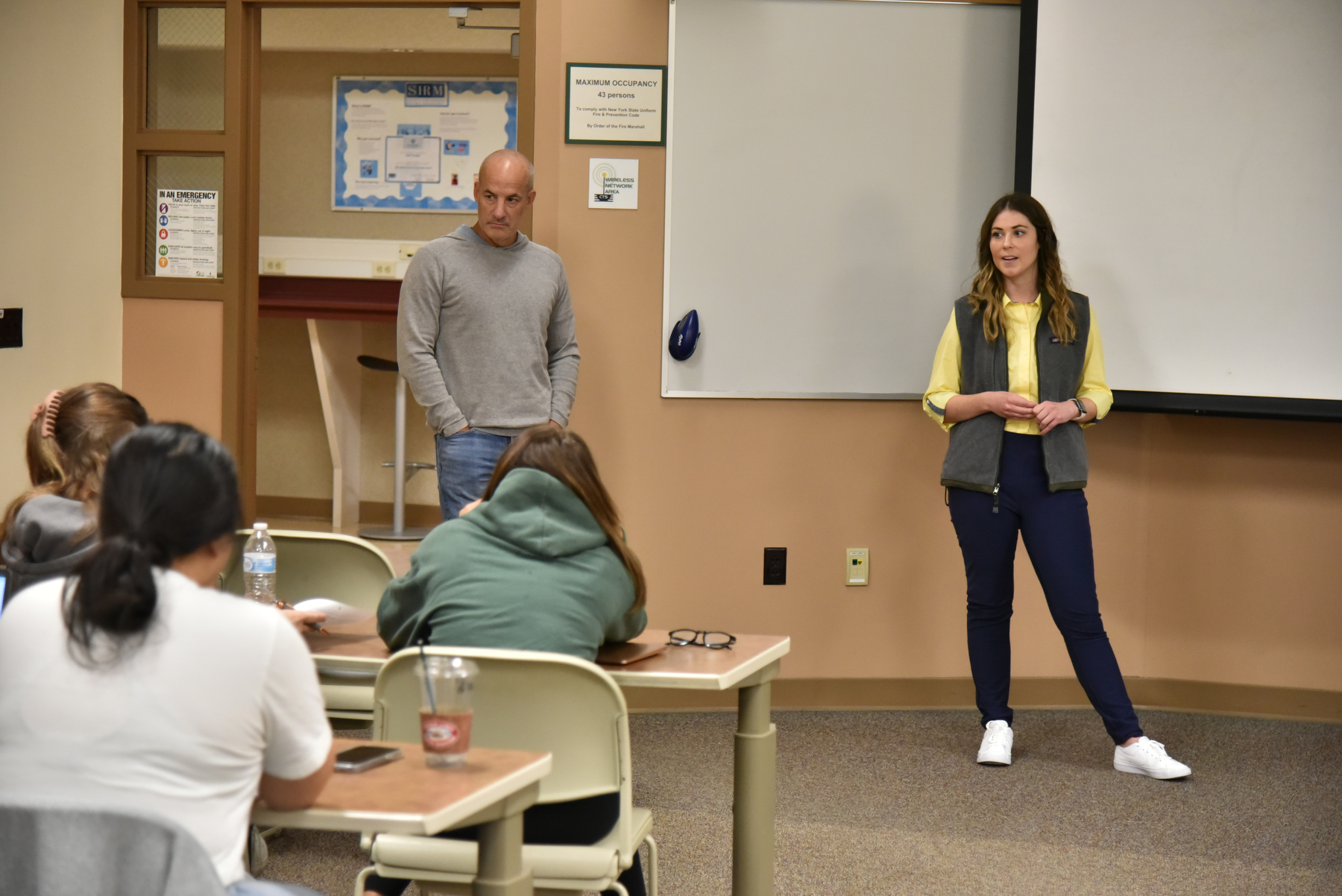 Holly Reitmeier '17 M'18 and Jim Triandiflou '88 speak in Holly Reickert’s “Marketing Principles” class in the School of Business. Part of the Alumni Sharing Knowledge program (ASK). Reitmeier is director of operations for Box Score Consulting.