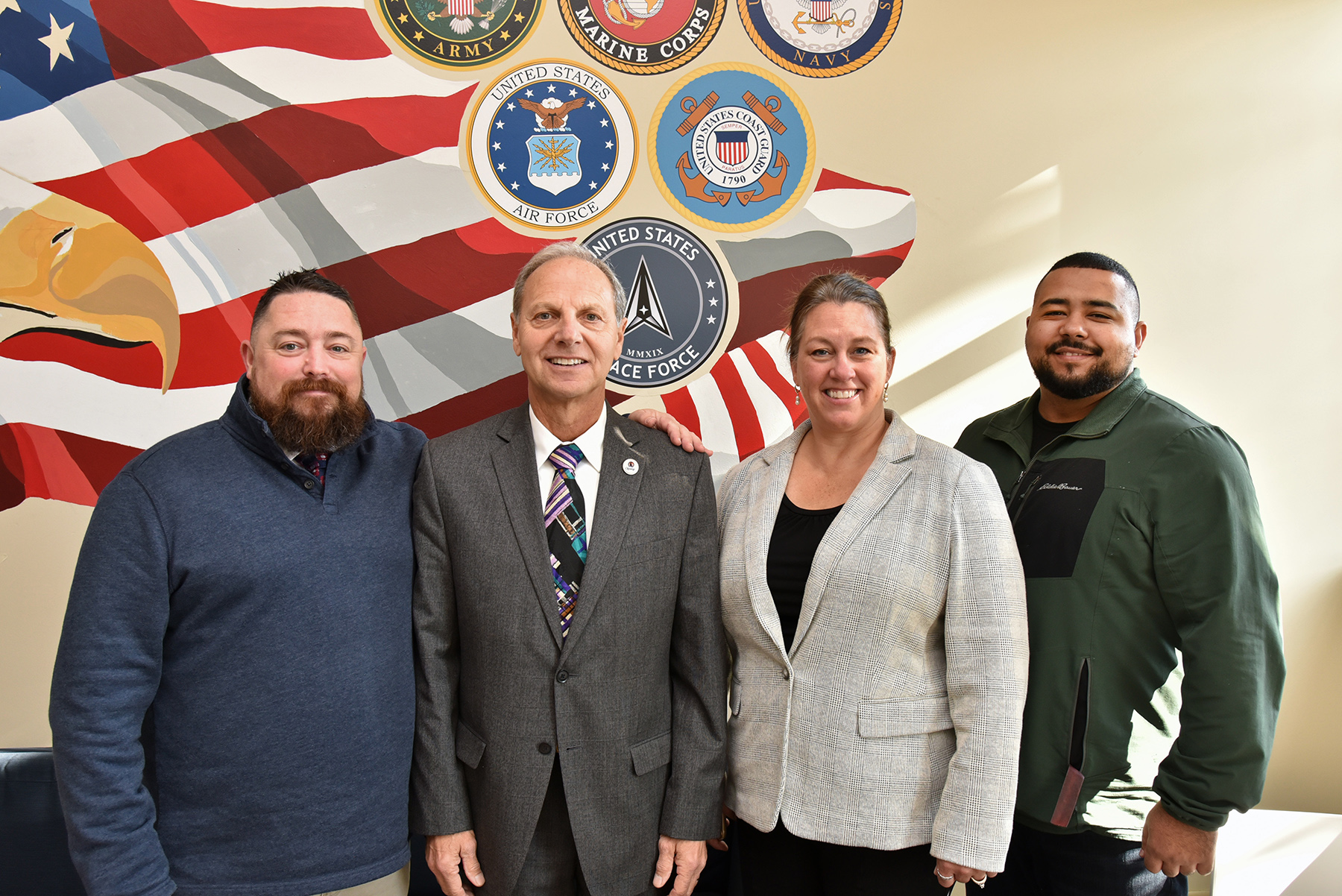 Veteran and military affiliated students were invited to the Veterans Lounge and Battle Buddy Center in Sheldon Hall to enjoy lunch and refreshments Nov. 13 in honor of Veterans Day. Marking the occasion are, from left: Ken Cisson, veteran and military services coordinator in the Division of Extended Learning; Robert Corradino, City of Oswego 7th Ward councilor and mayor elect; Jill Pippin, dean for Extended Learning; and Adam Coe, a junior operations management major and a military veteran.