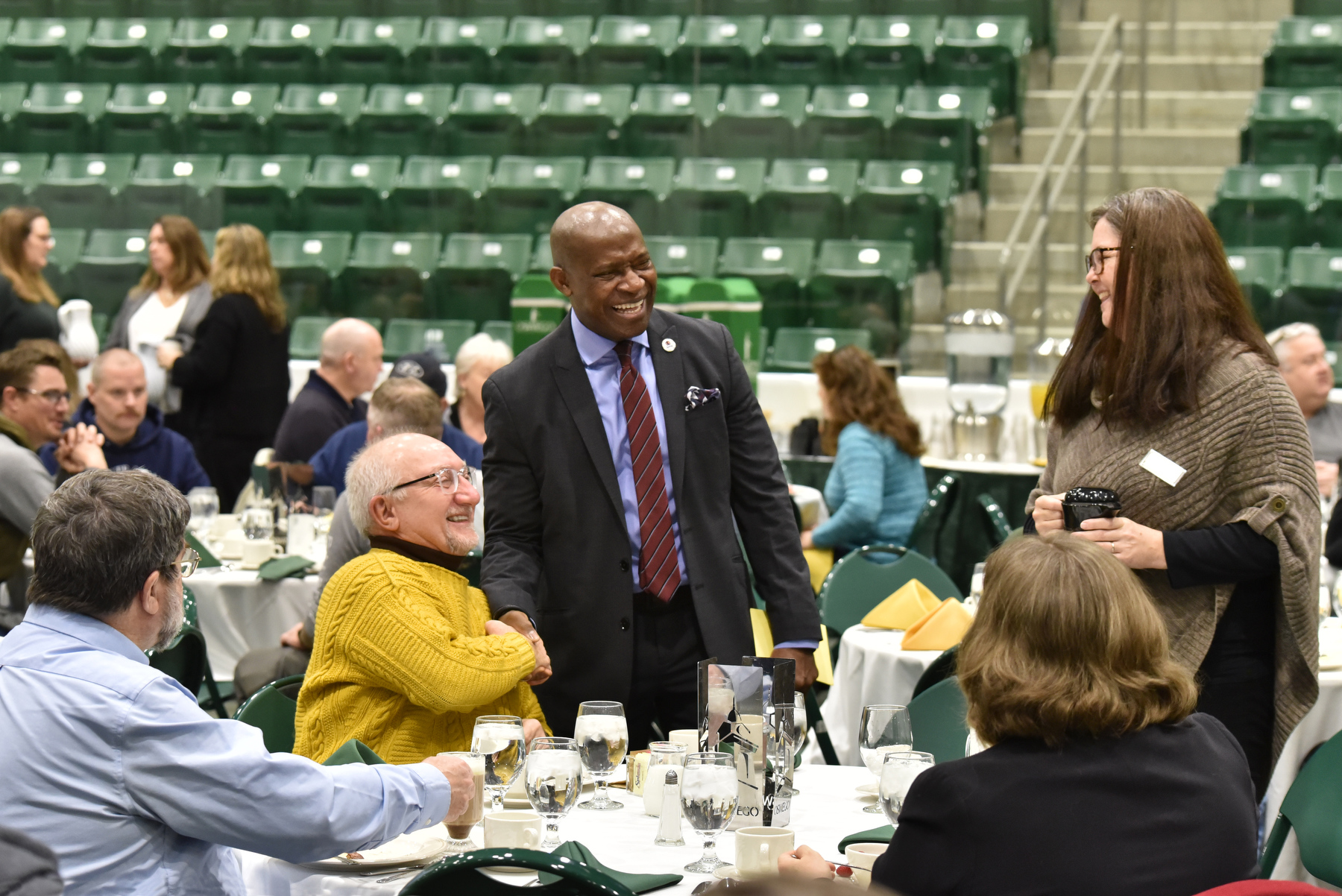 The Campus Community Breakfast, held Dec. 13 and hosted by President Peter O. Nwosu, provided faculty and staff the opportunity to gather and commemorate the end of a successful fall semester and to look forward to a well-deserved winter break. Pictured, President Nwosu shakes hands with David Bozak, a psychology department faculty member, while greeting everyone in attendees in the Deborah F. Stanley Arena and Convocation Hall in Marano Campus Center.