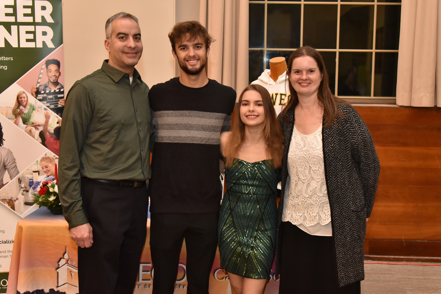 The Commencement Eve Reception held Dec. 15 in the Sheldon Hall ballroom celebrated the December Class of 2023 and welcomed the newest members of the Oswego Alumni Association. Calista Sassalos (third from left), one of the hundreds of graduates receiving diplomas at Commencement the next day, takes a photo with her family.
