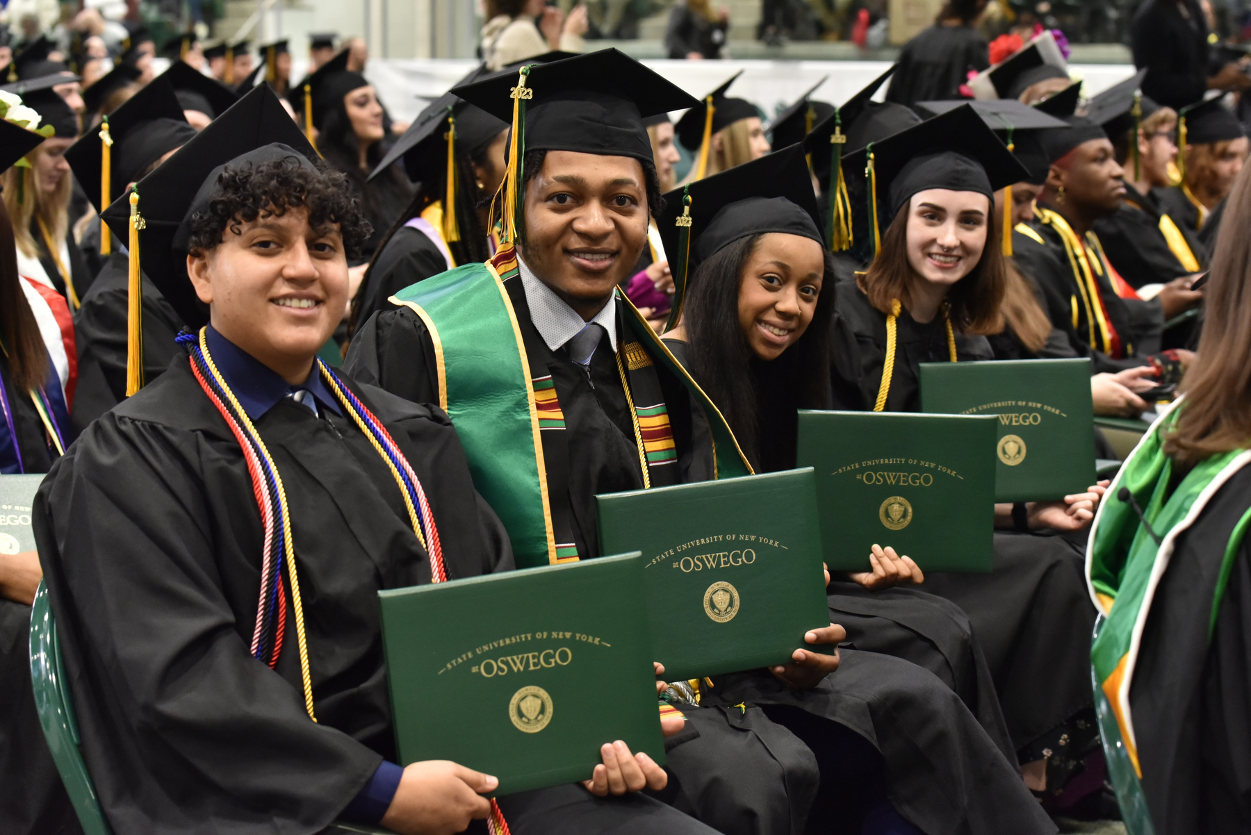 Graduates proudly display their diploma covers at the December Commencement.