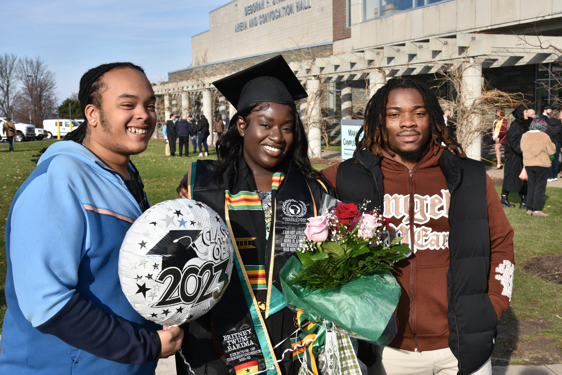 Britney Twum-Barim, a School of Education graduate, celebrates with supporters after the December Commencement ceremony held in the Deborah F. Stanley Arena and Convocation Hall in Marano Campus Center.