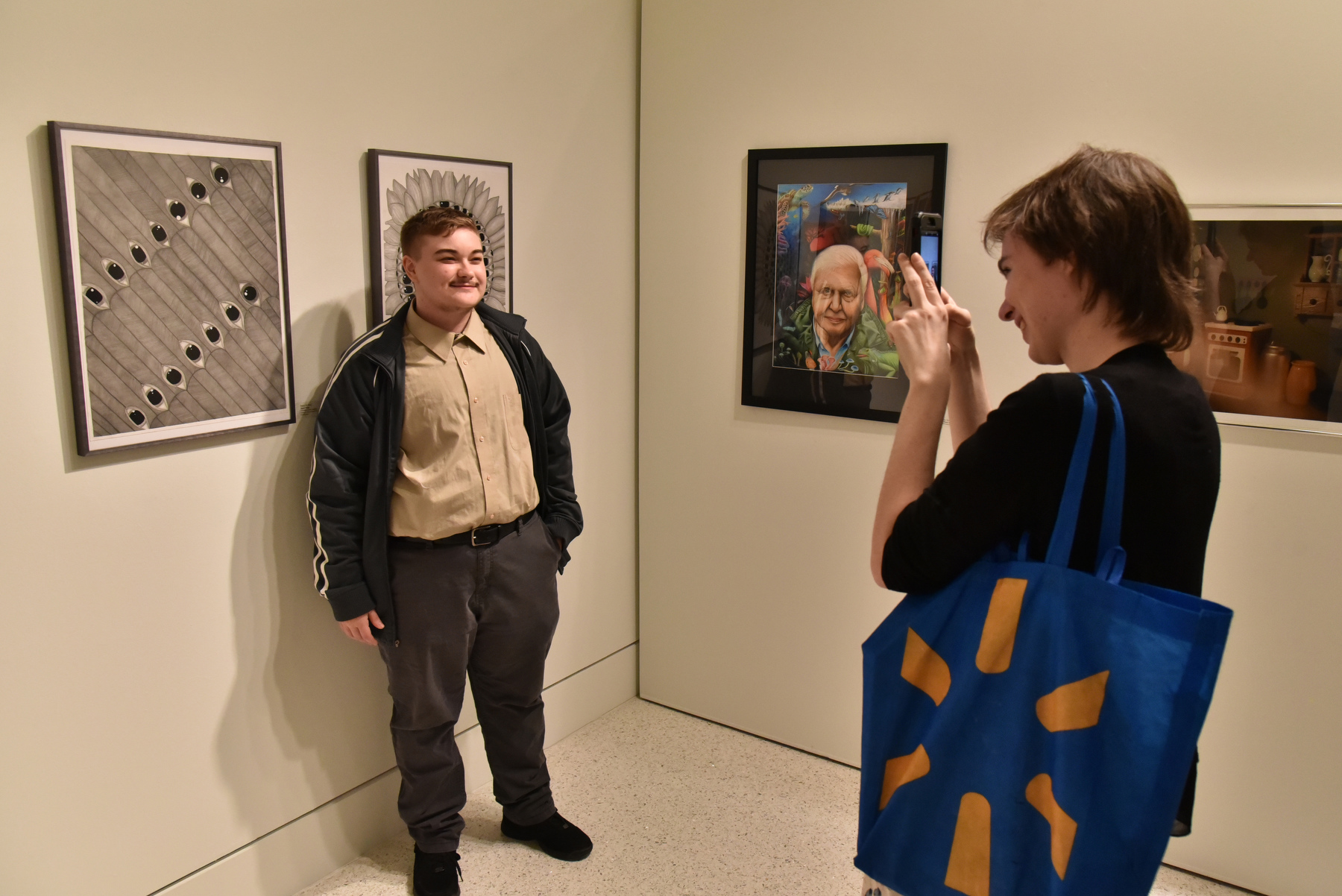In its 61st year, the Juried Student Art Exhibition annually features works of art created by SUNY Oswego students, open to all students. Jurors selected 99 pieces for this exhibition of various media, styles and approaches, from traditional to digital. Pictured is artist Danny Rafferty and friend with his paintings and drawings. The show ran from Jan. 26 to Feb. 18, in Tyler Art Gallery.