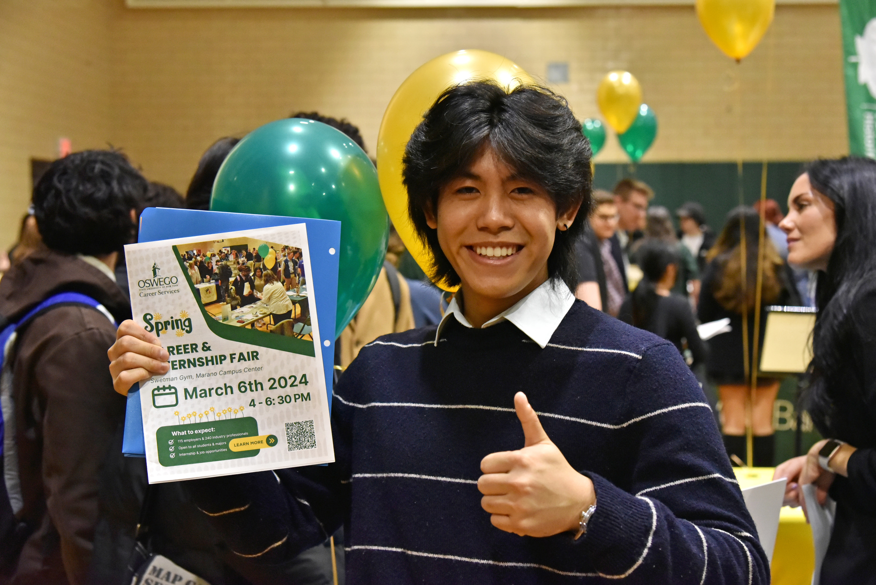 Adrian Almendral, a freshman finance major, shows his enthusiasm for the Spring 2024 Career and Internship Fair held March 6 in the Swetman Gym. Oswego students networked with over 100 employers and professionals at the event hosted by Career Services.