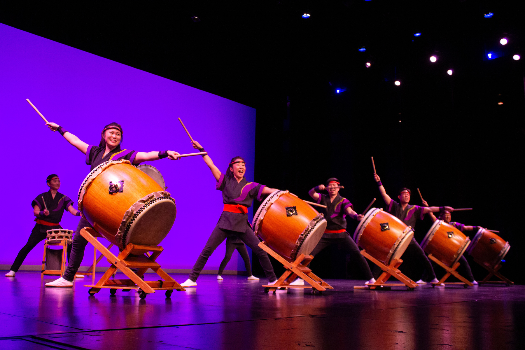 San Jose Taiko performed as part of the ARTSwego performing arts series on March 6 in Waterman Theatre. This image shows a line of drummers performing.