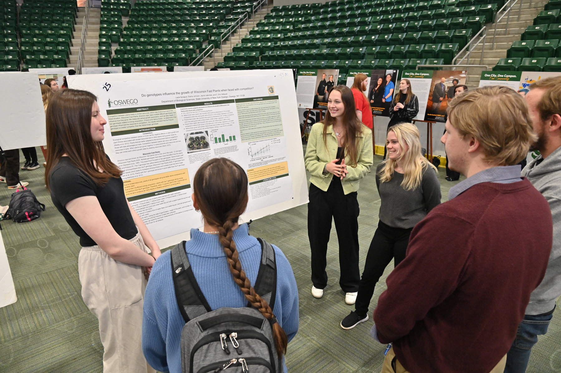 Students showcase their research work in the popular poster session during Quest. Biological sciences students Elaina Johnson, Jayna Laferriere and Layla Sprague present their research titled "Do genotypes influence the growth of Wisconsin Fast Plants when faced with competition?"