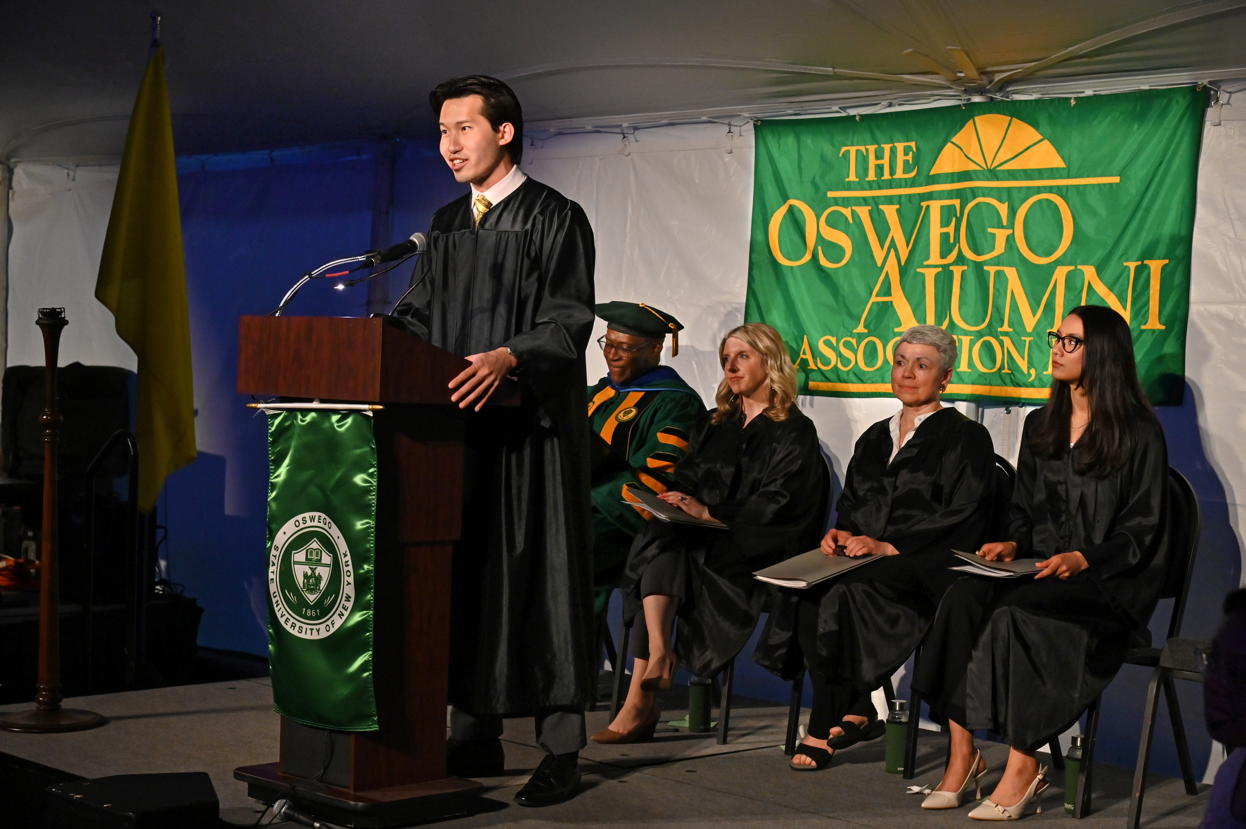 Eason Lee ’23 M’25, student emcee for the Commencement Eve Torchlight Ceremony May 16, offers remarks from the platform.