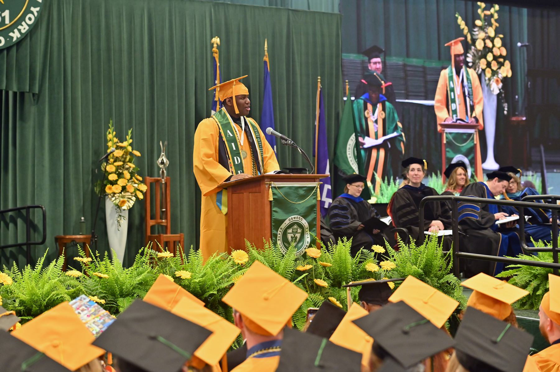 Aiden Wilson, Student Association president and recipient of the Outstanding Senior Award by the Oswego Alumni Association, gives the Student Address for each of the three ceremonies, here at the 9 a.m. commencement ceremony for College of Liberal Arts and Sciences.