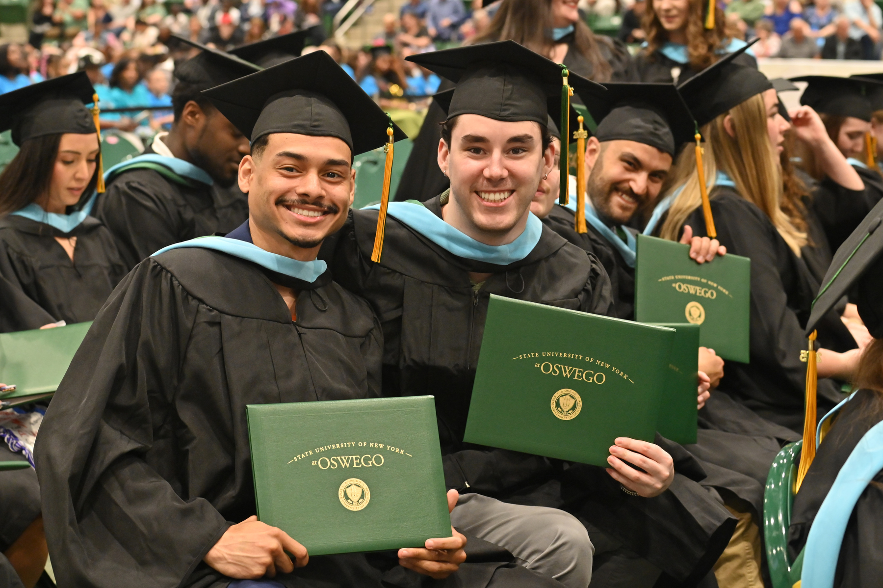 Master's in education graduates take a moment to celebrate their accomplishments during the 4 p.m. ceremony.