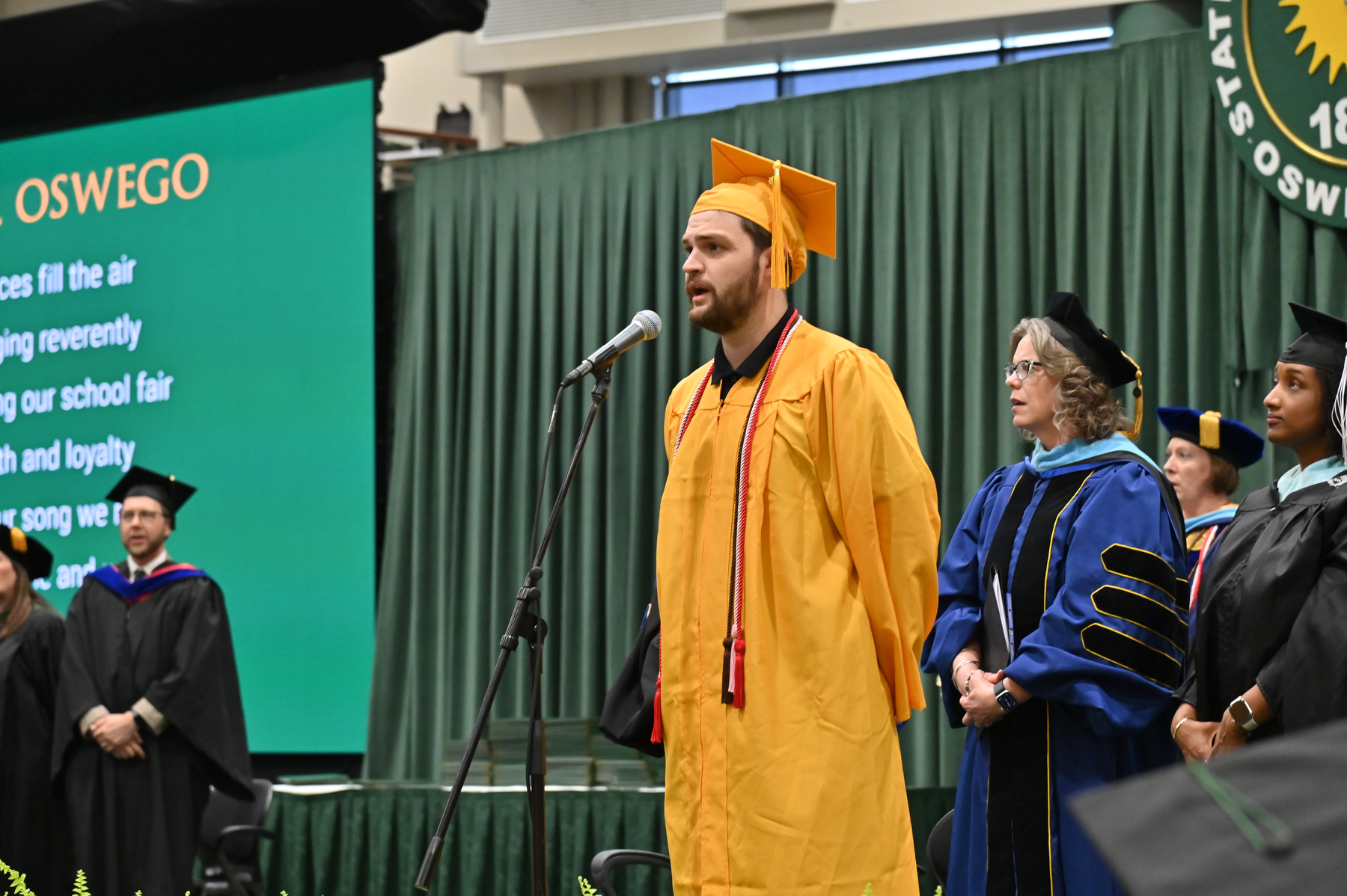 Timothy Altbacker sings the Alma Mater at the conclusion of the 4 p.m. ceremony.
