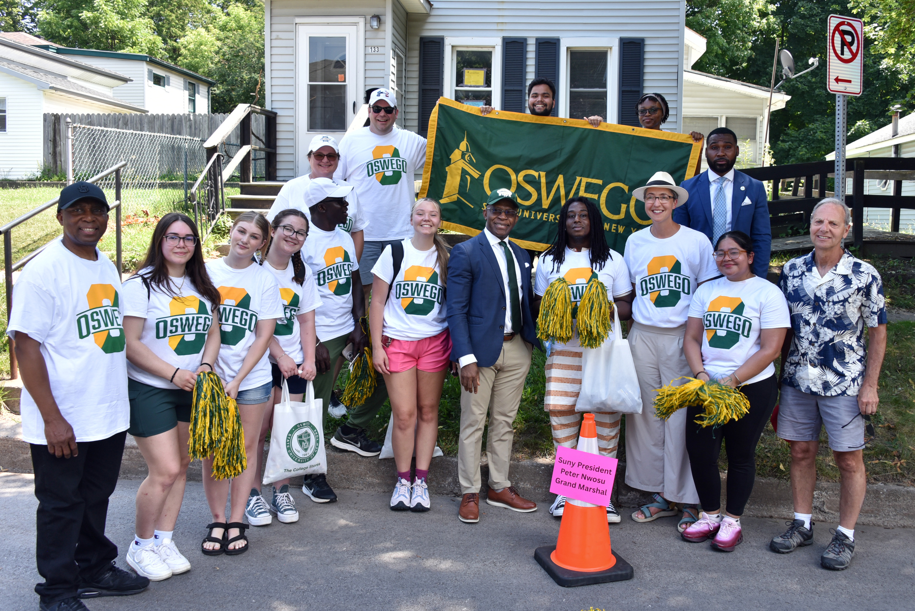 SUNY Oswego students and staff gather with President Peter O. Nwosu and City of Oswego Mayor Robert Corradino as they assemble to participate in Oswego's Independence Day Parade. President Nwosu served as grand marshal for this year's annual event held July 6.