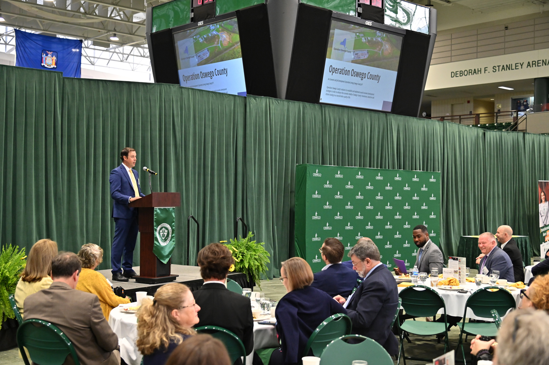 Austin Wheelock, executive director for Operation Oswego County, speaks during the 2025–26 Opening Breakfast held Aug. 19, in the Deborah F. Stanley Arena and Convocation Hall.