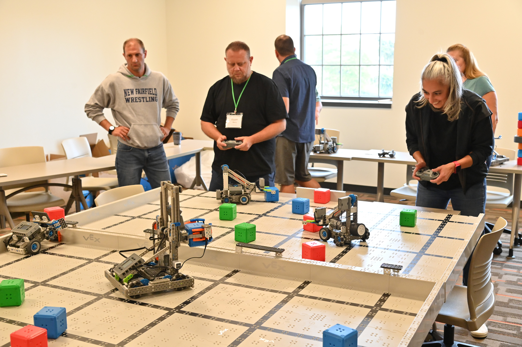 Ten technology teachers from across New York state visited SUNY Oswego Aug. 19 to train on new robotics curriculum thanks to a partnership between the university and Micron Technology to bolster K-12 STEM education in Central New York and beyond. Pictured are some of the participants operating their robots during a friendly competition.