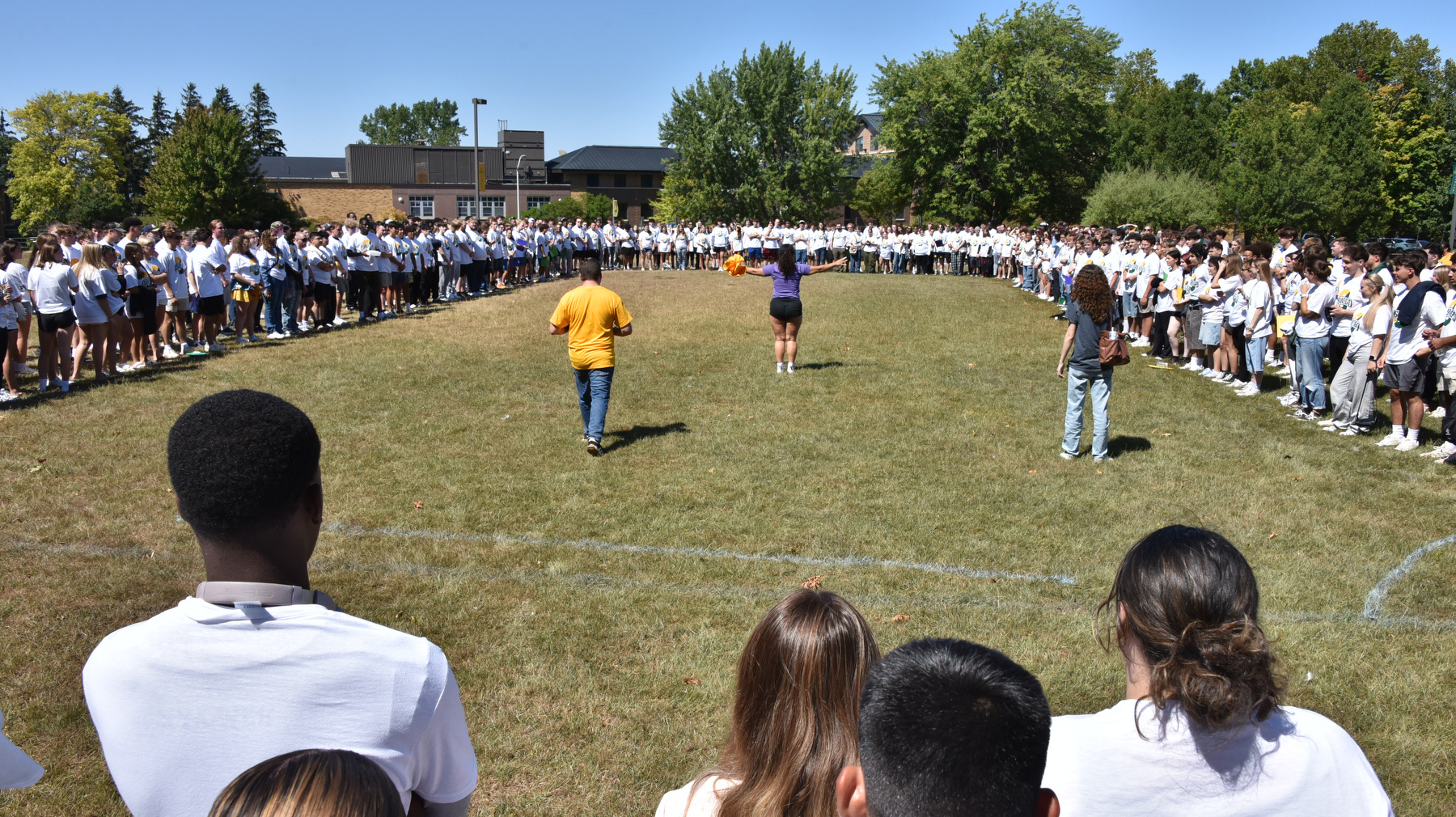 Students, faculty and staff start making the letter “O” for the annual photo, this year on the Lee Hall field.