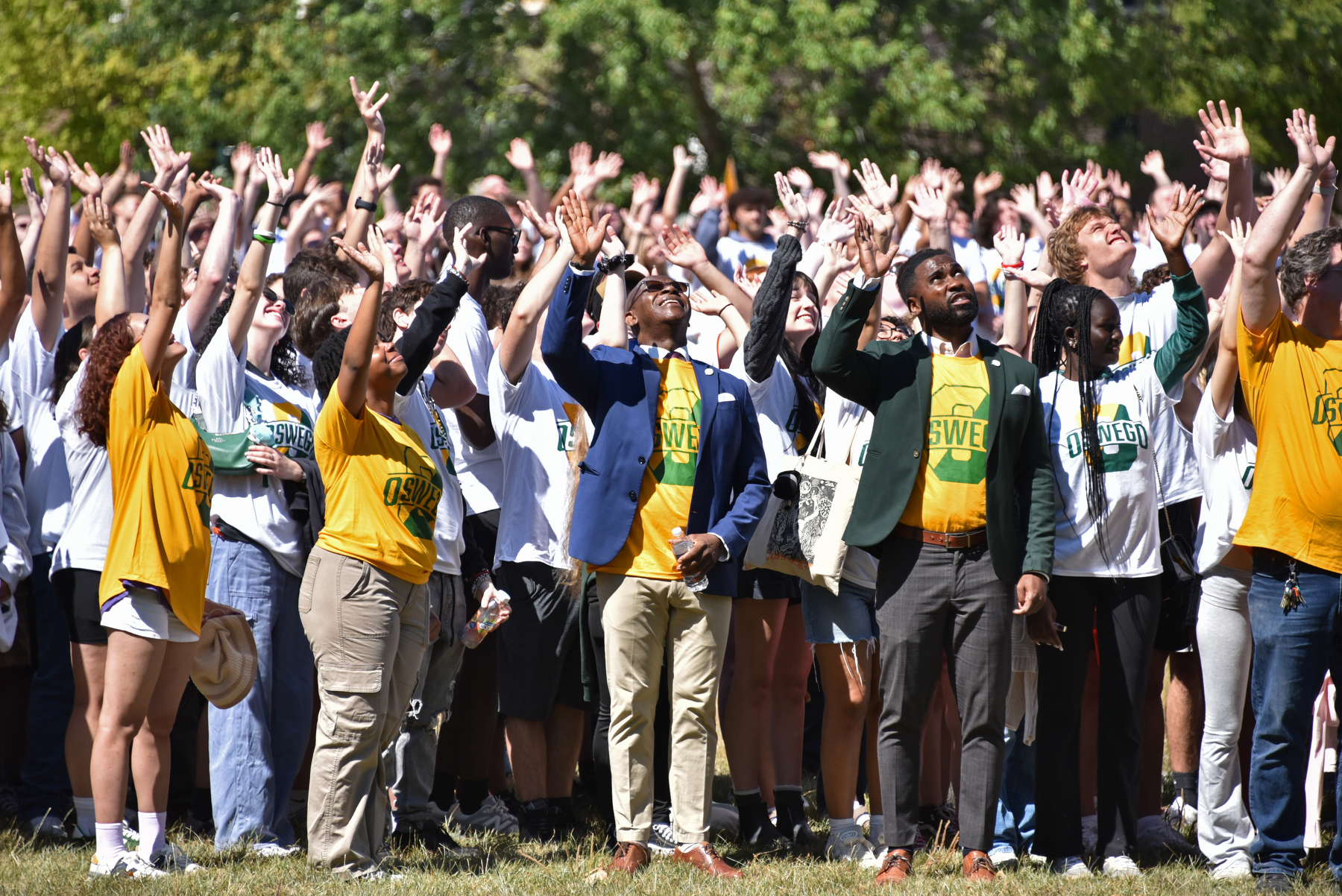President Peter. O. Nwosu and Jamal Coleman, director of operations for the Office of the President, join with students in waving to the aerial drone camera for this year's “O” Photo, an annual tradition.