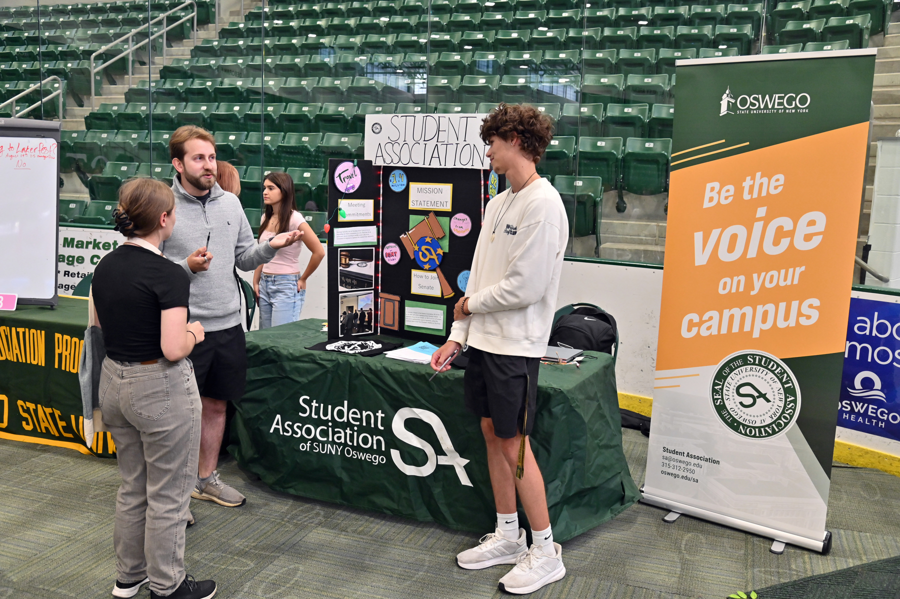 Staffing the Student Involvement Fair’s Student Association table are Luke Kapczak (left, gray hoodie), a senior finance major and SA director of finance, and James Clough (right), a junior computer science and electrical engineering major and SA secretary.