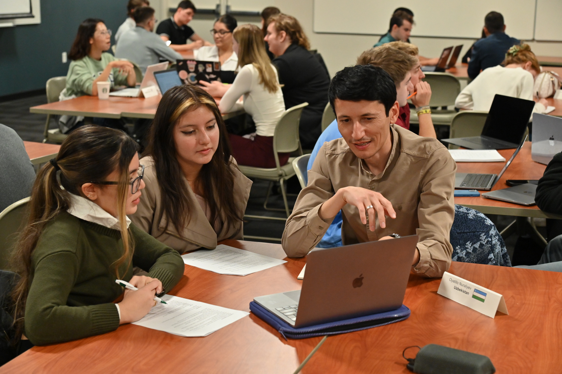 The Humphrey Fellows from the Maxwell School at Syracuse University visited with business students in Paul Babiarz's Management 469 class on Oct. 16 in Penfield Library. Pictured are students with Oyatillo Nuraliyev from Uzbekistan.