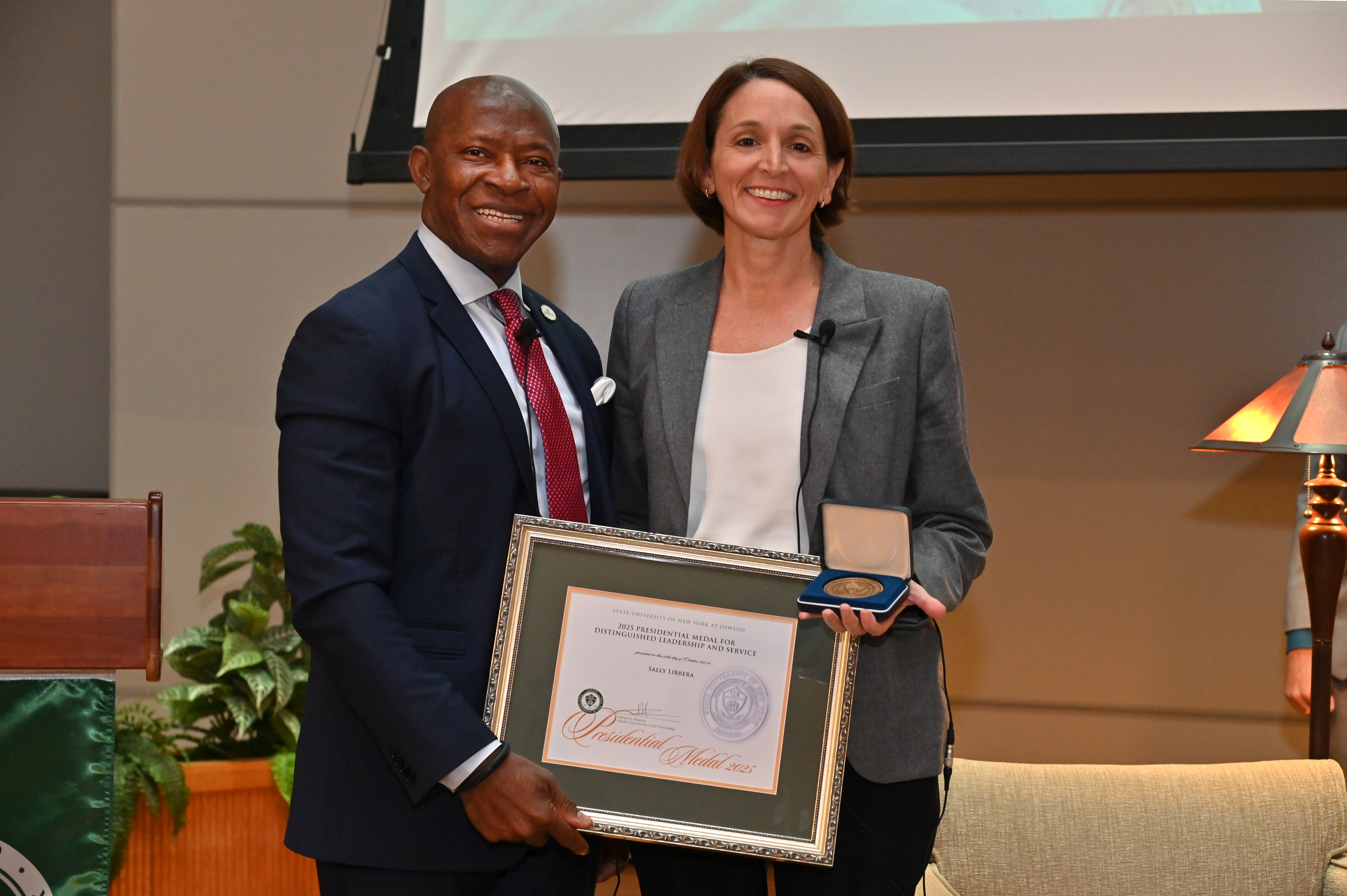 Sally Librera, president of National Grid NY, received the Presidential Medal presented by SUNY Oswego President Peter O. Nwosu on Oct. 24 during the second annual Sheldon Lecture on Leadership and Service in the Sheldon Hall Ballroom where she was guest speaker. 