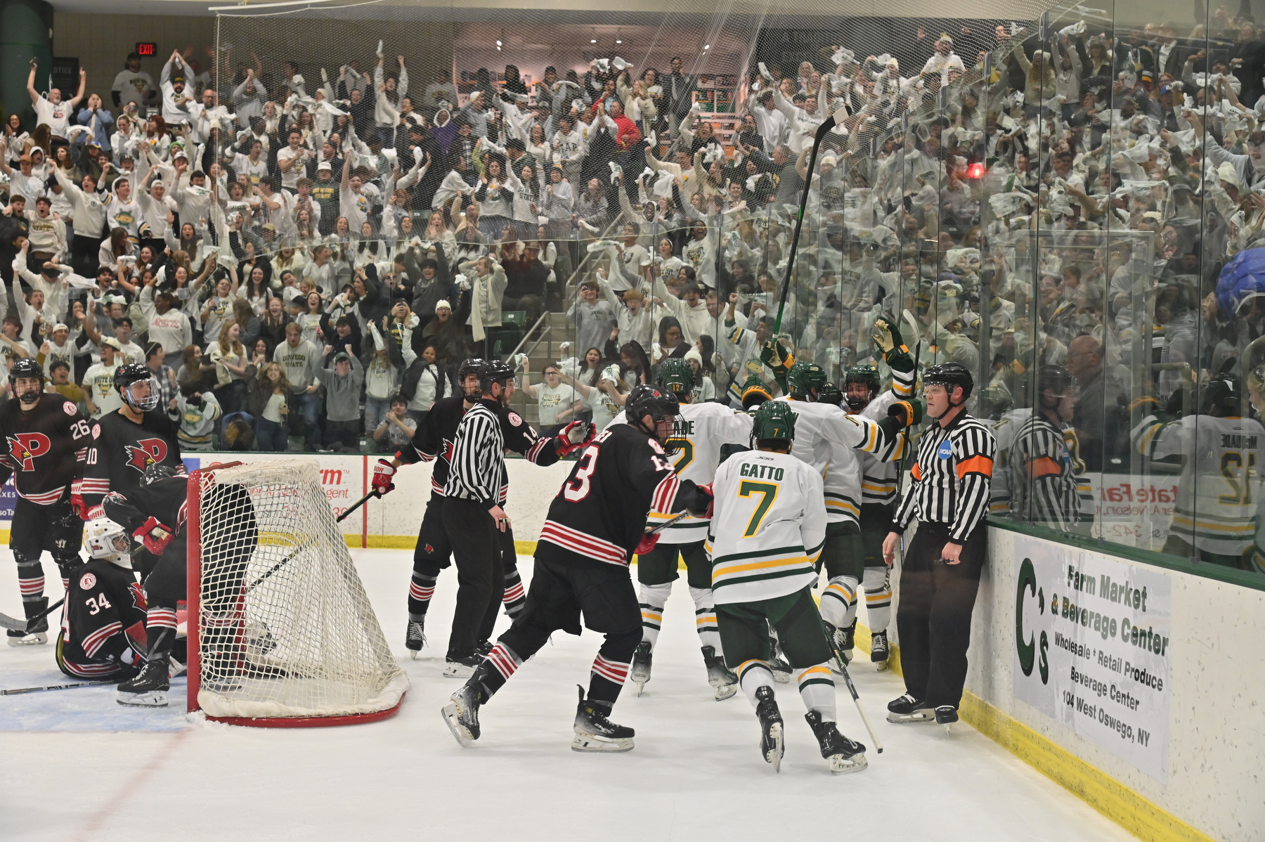The Laker men’s hockey team celebrates Oswego’s third and tie-breaking goal in the final second of the game to defeat archrival Plattsburgh in front of a packed and loud White Out crowd at the Deborah F. Stanley Arena and Convocation Hall on Nov. 14. 