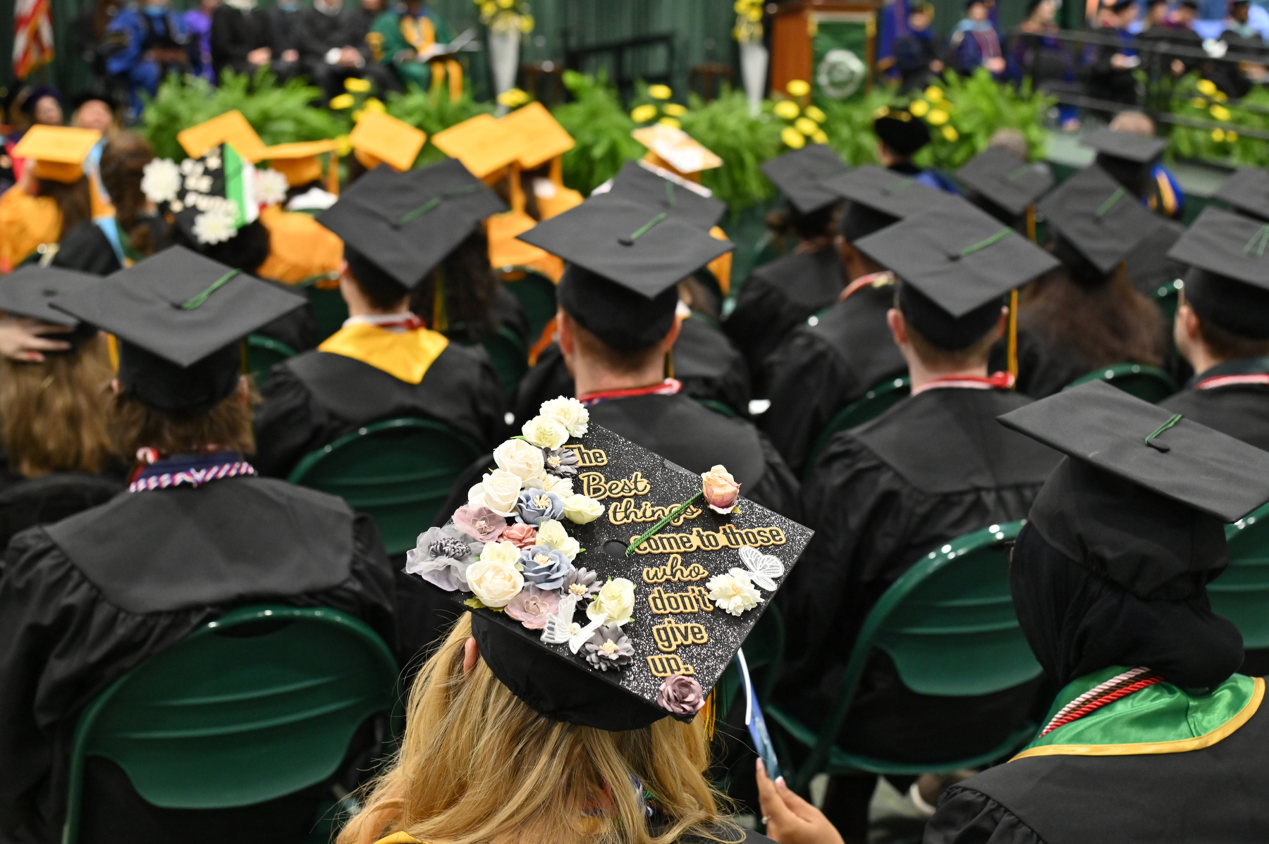 Graduation caps decorated with meaningful verse abound at Commencement, such as this one with the philosophy that the best things come to those who don't give up.