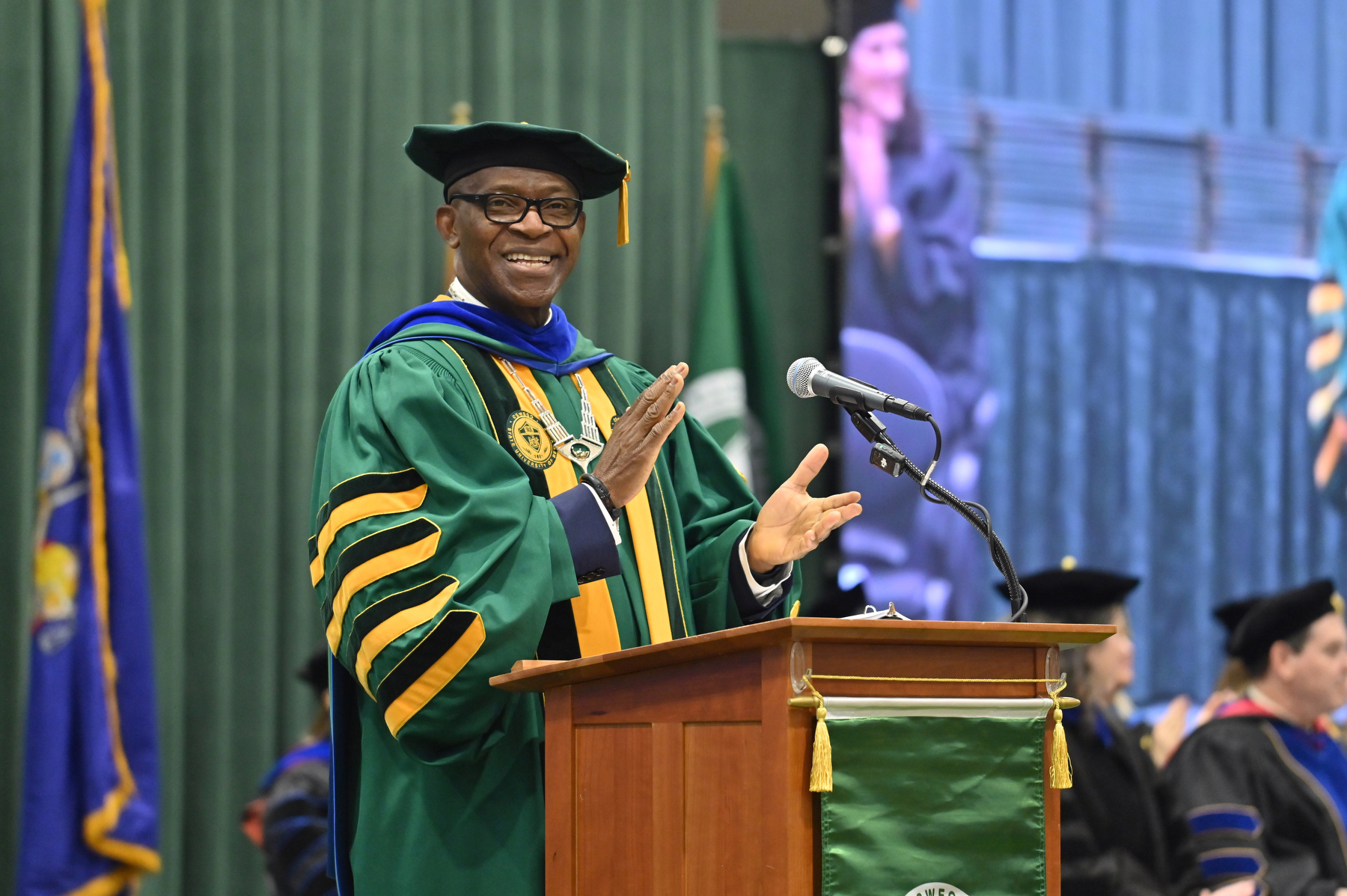 President Peter O. Nwosu congratulates graduates at December Commencement on Dec. 13. 