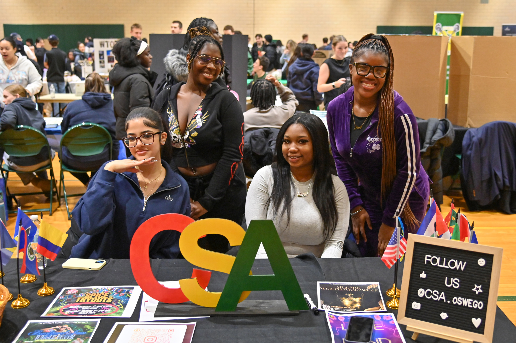 The Spring Student Involvement Fair, Feb. 4 in Swetman Gym, hosted by the Office of Student Engagement and Leadership, encourages students to explore Oswego's 150+ clubs and organizations. Caribbean Student Association officers present included, from left, Leslie Vargas, director of correspondence; Sarah Harris, vice president and director of entertainment; Kaiya Williams, treasurer; and Dayna Purrier, president.