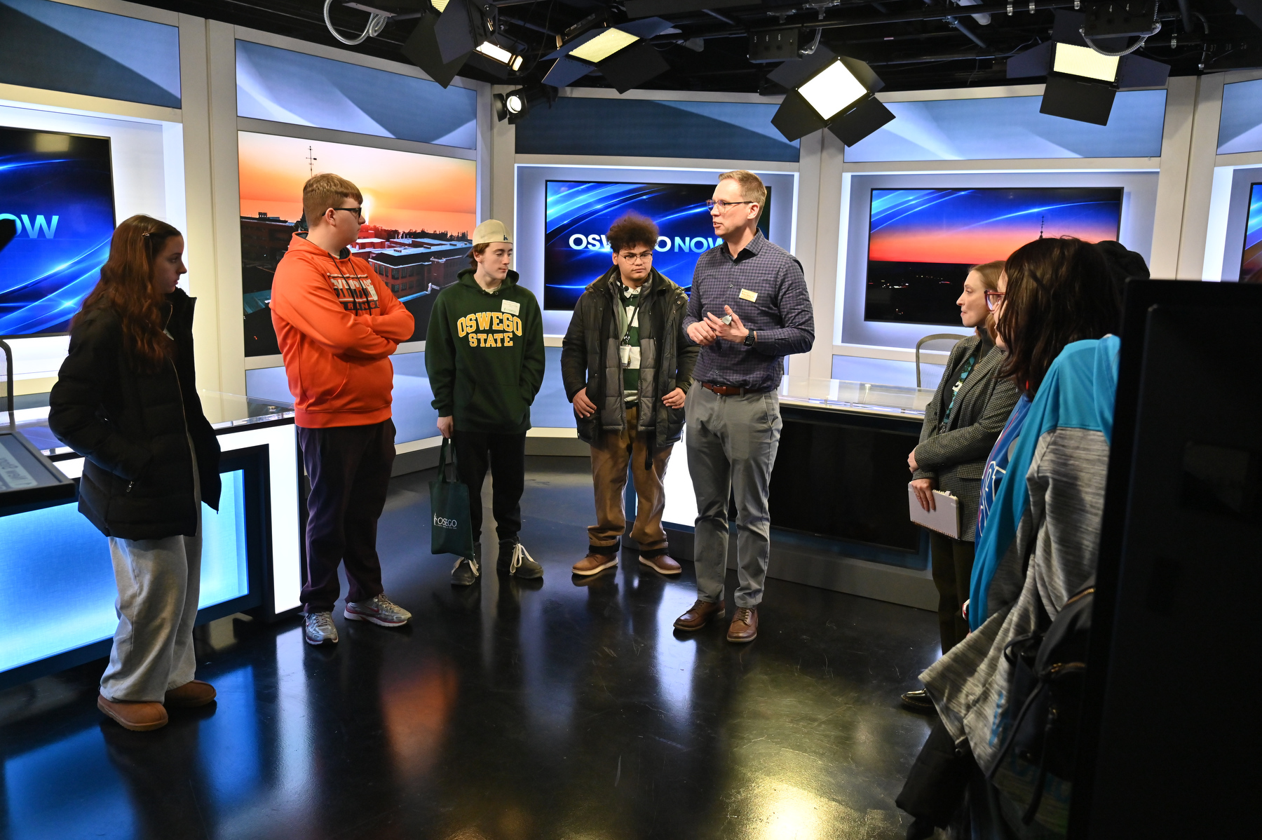 SUNY Oswego Direct Day featured tours of campus facilities, including Michael Riecke, chair of communication studies, and Davana Robedee, Tyler Art Gallery director, shown showcasing the university's new Hewitt Hall broadcast facilities. 